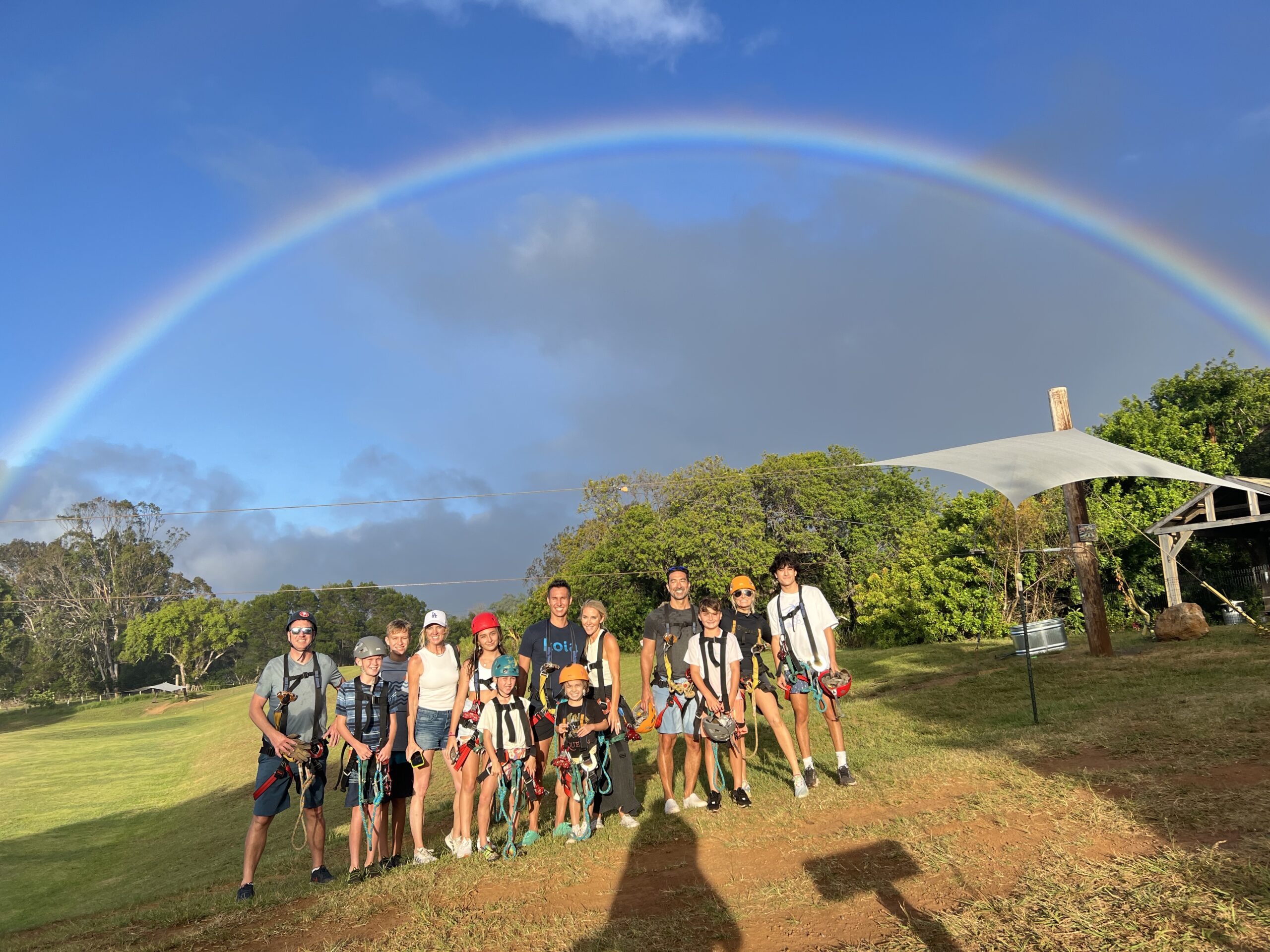 family standing under a rainbow