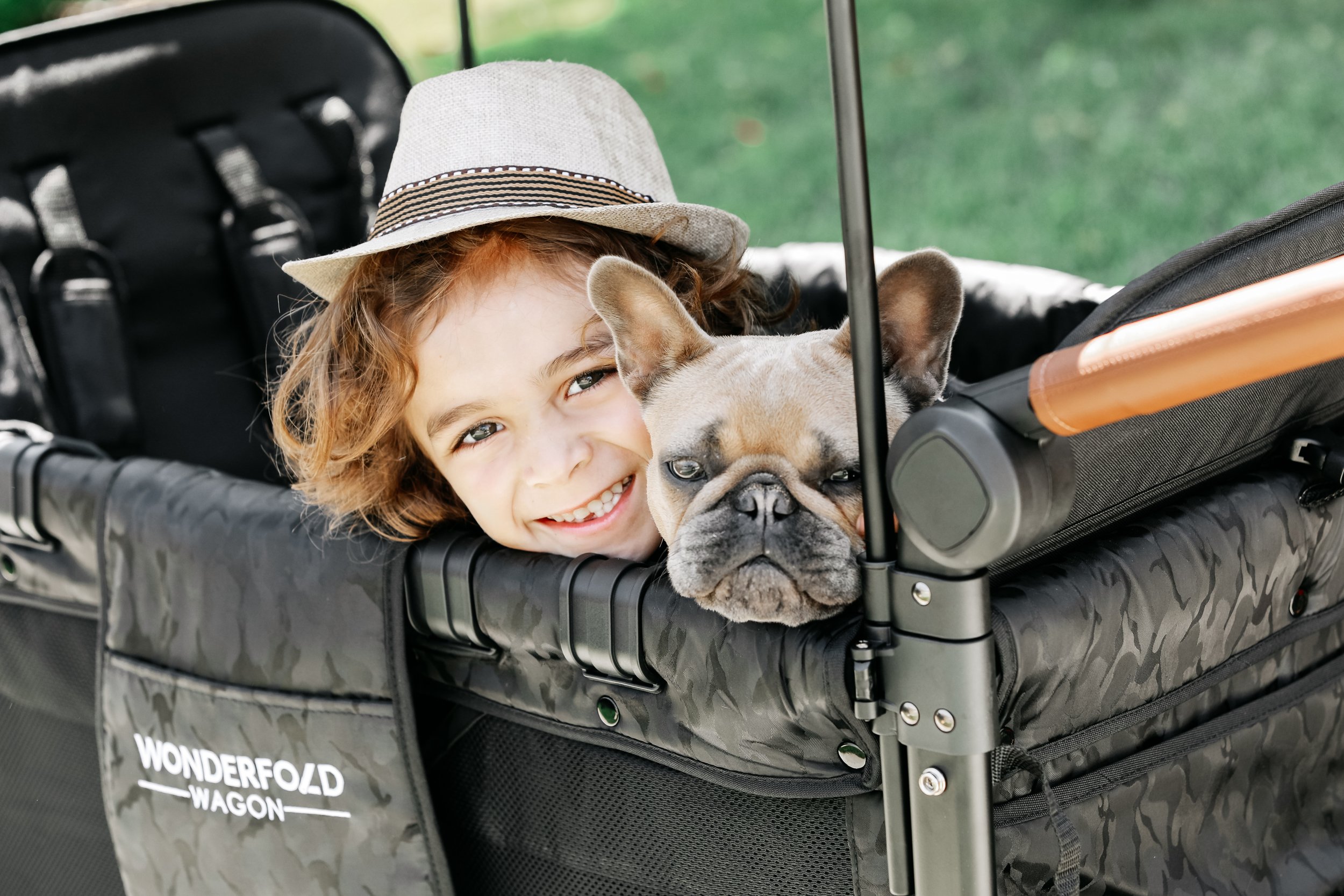 boy hugging his dog in a wagon