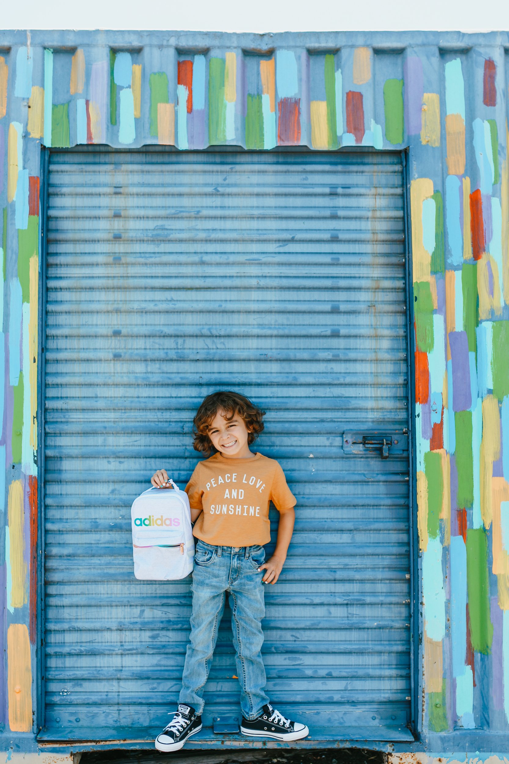 boy holding backpack