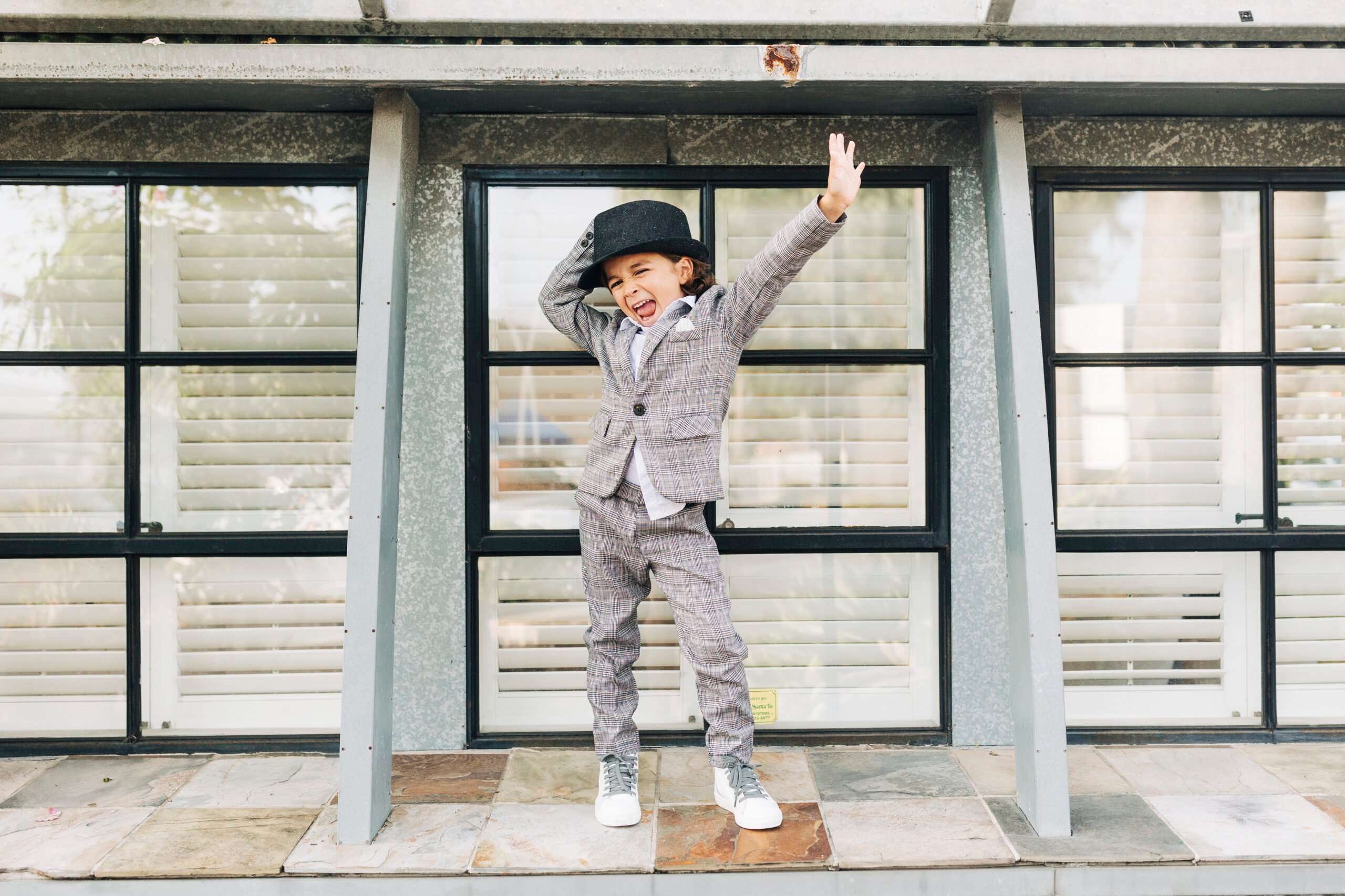 boy dancing in a suit and hat