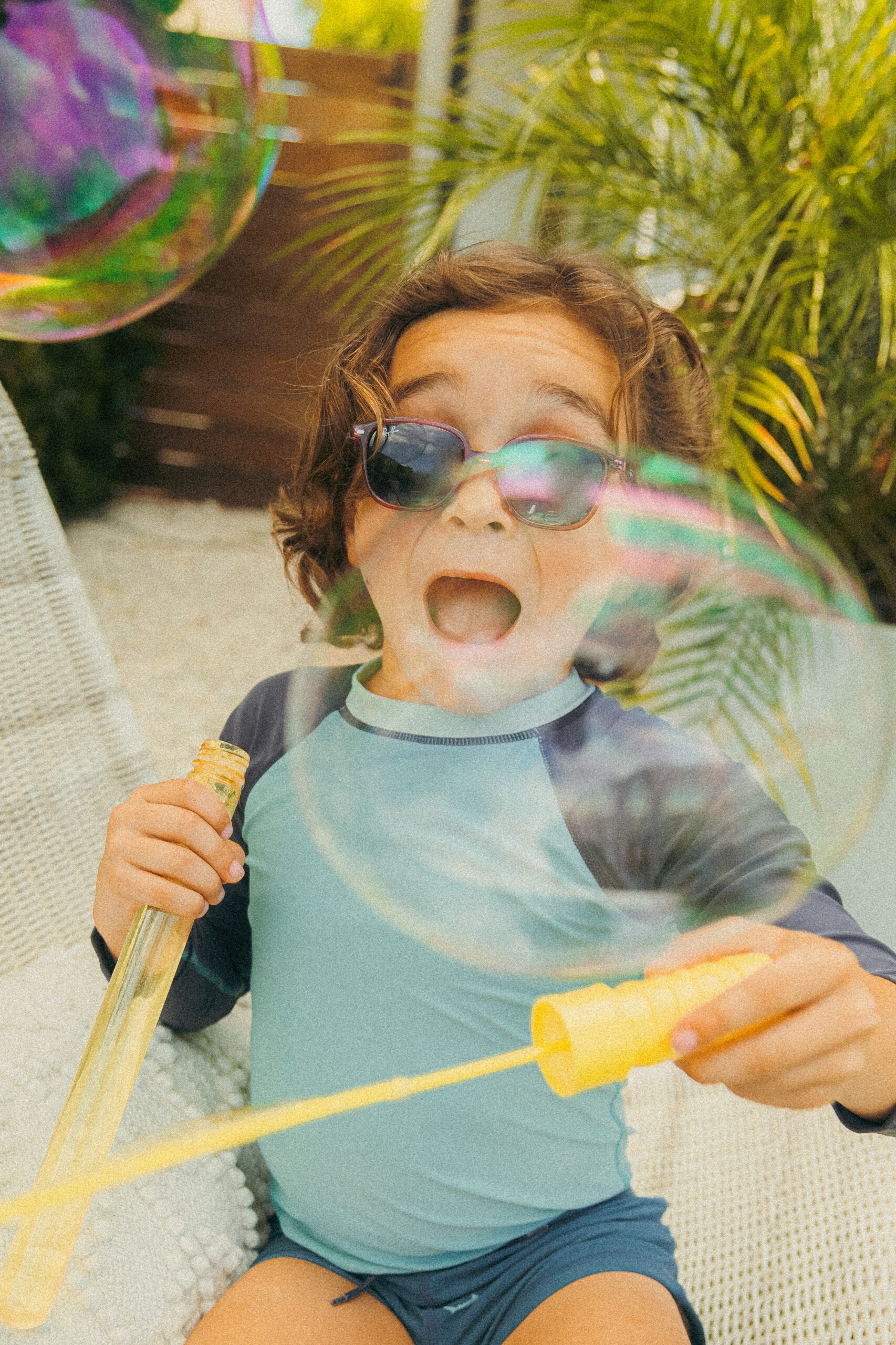 boy happy blowing bubbles