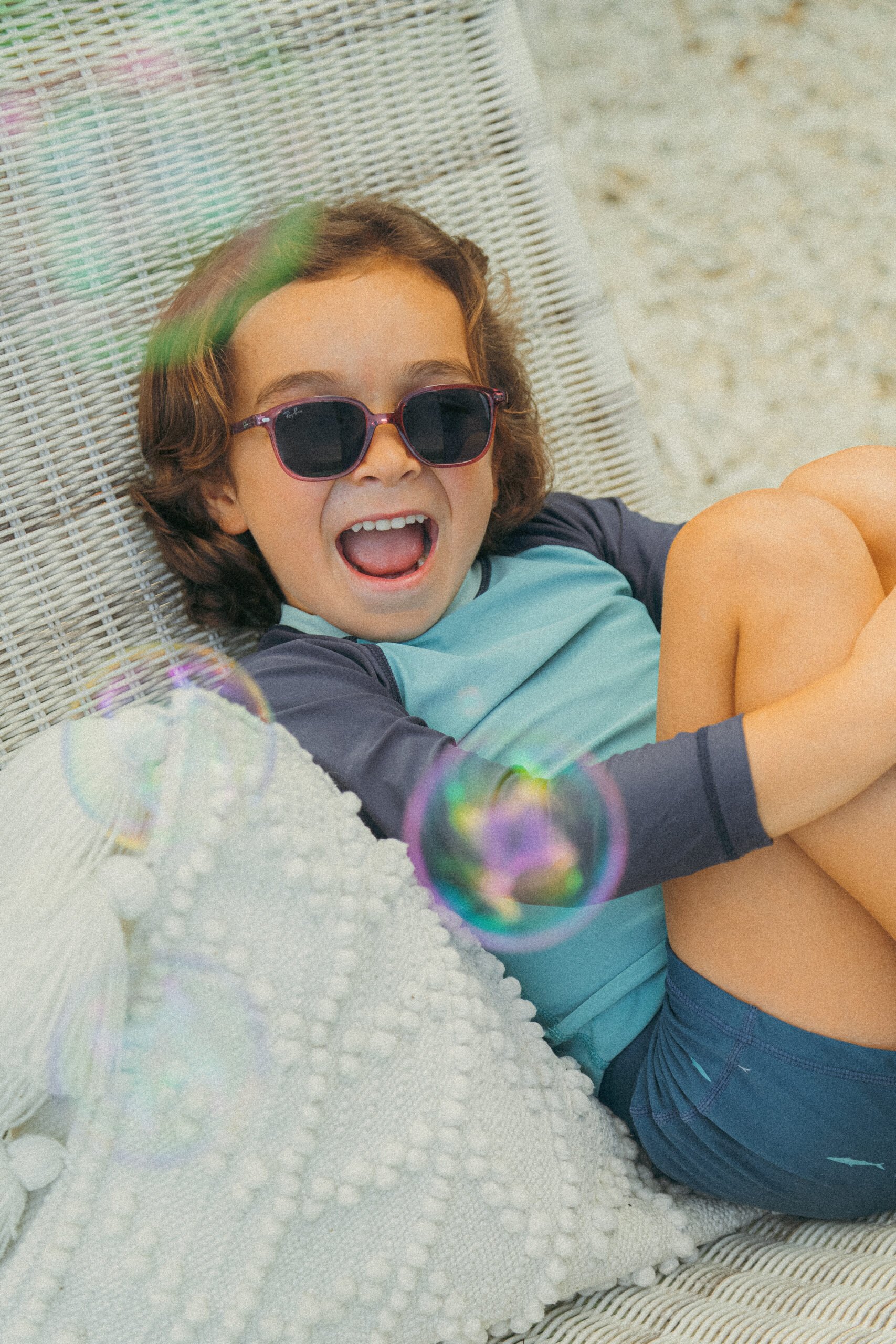 kid laughing in sunglasses
