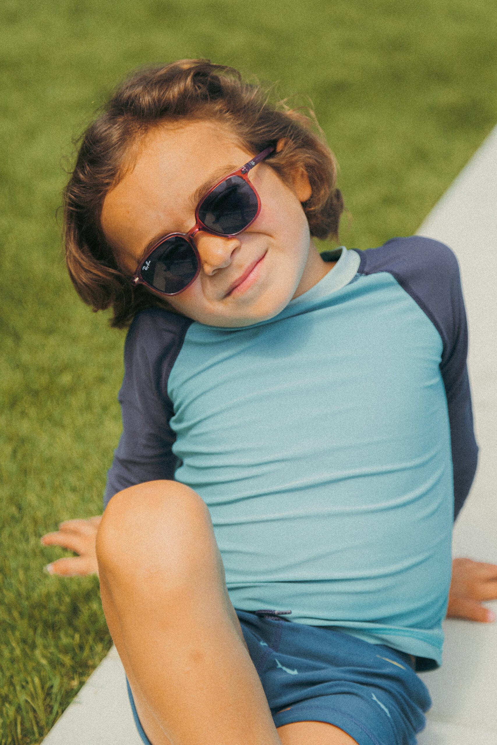 boy lounging in the grass