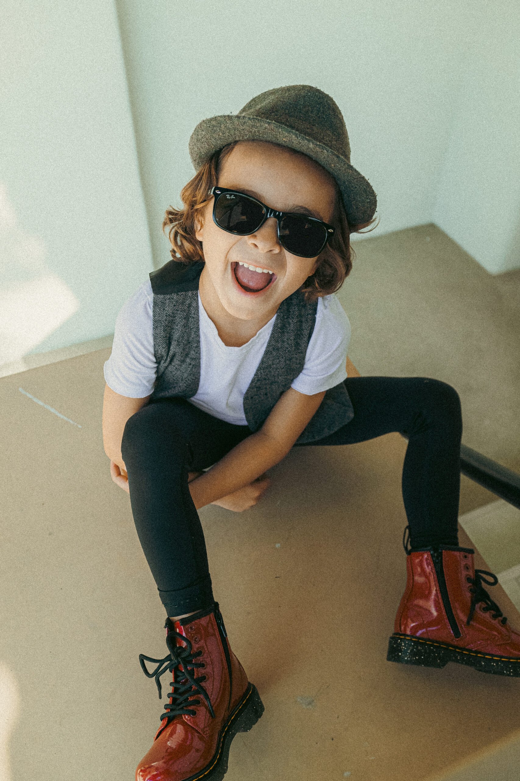 boy laughing with sunglasses on