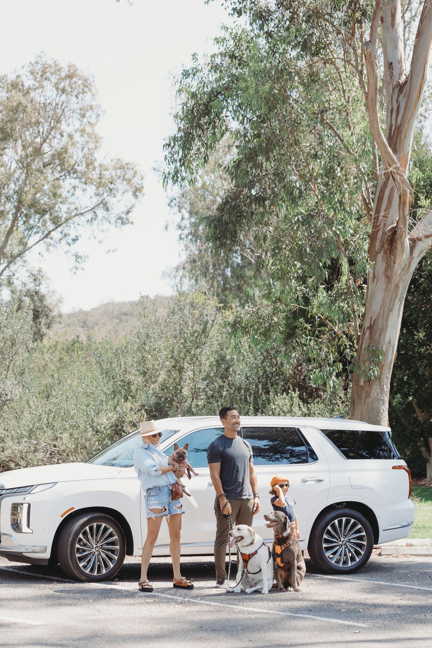 family standing by their suv