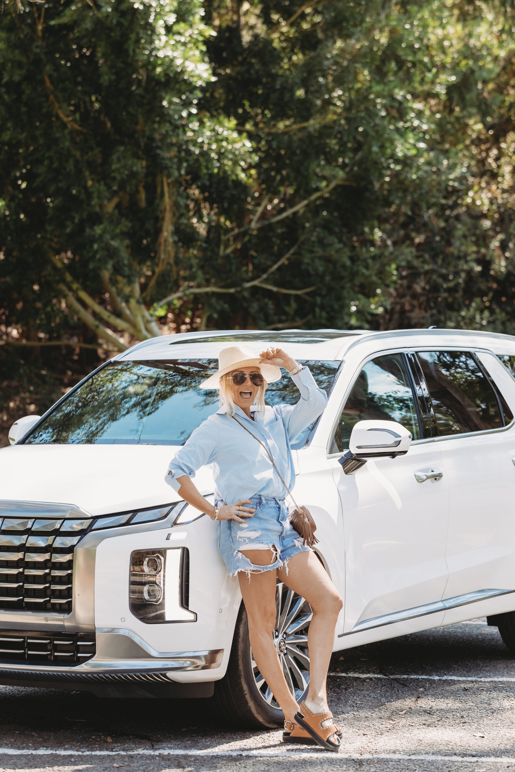 woman leaning on her suv