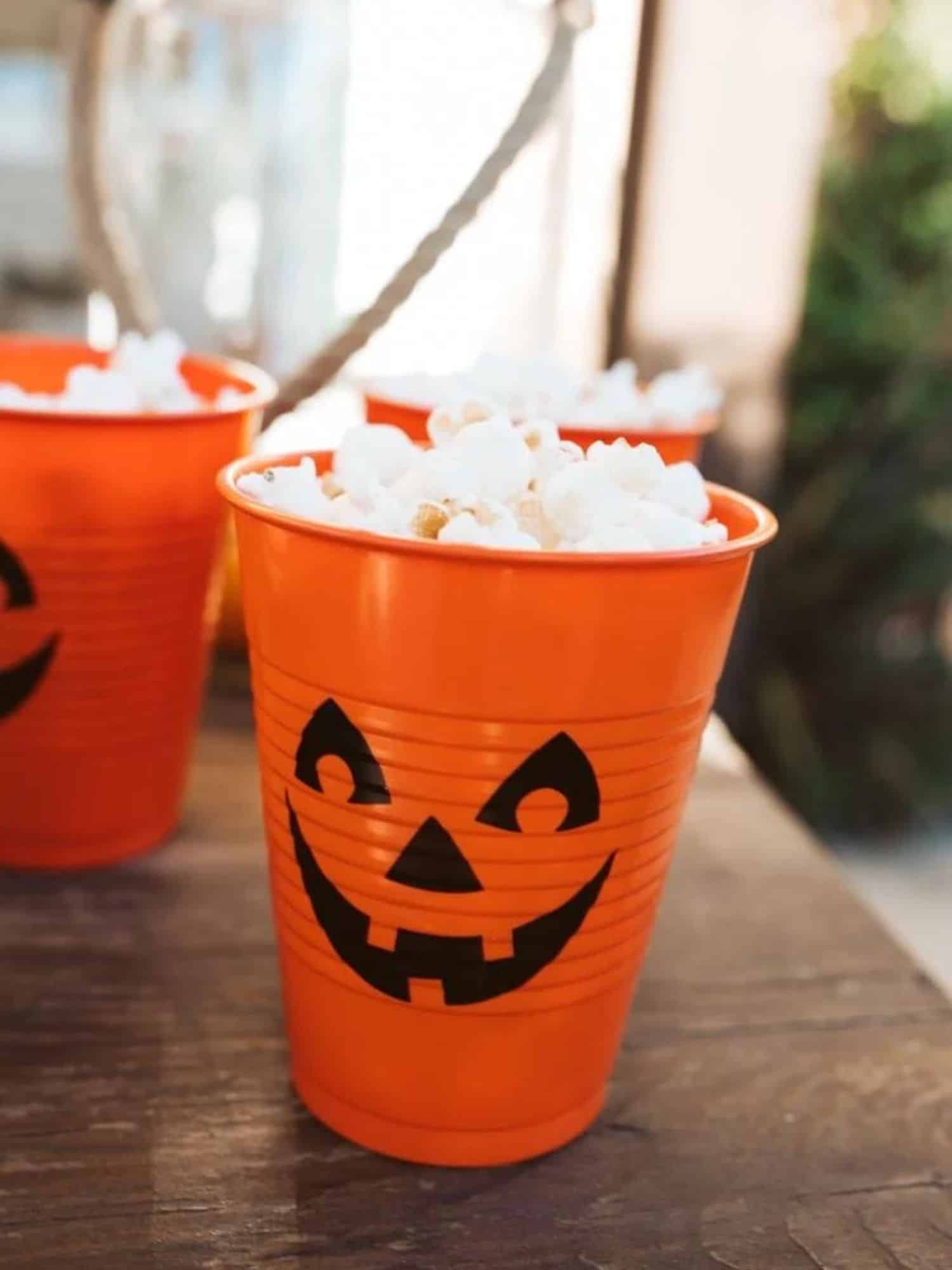 orange cup made into a jack o lantern