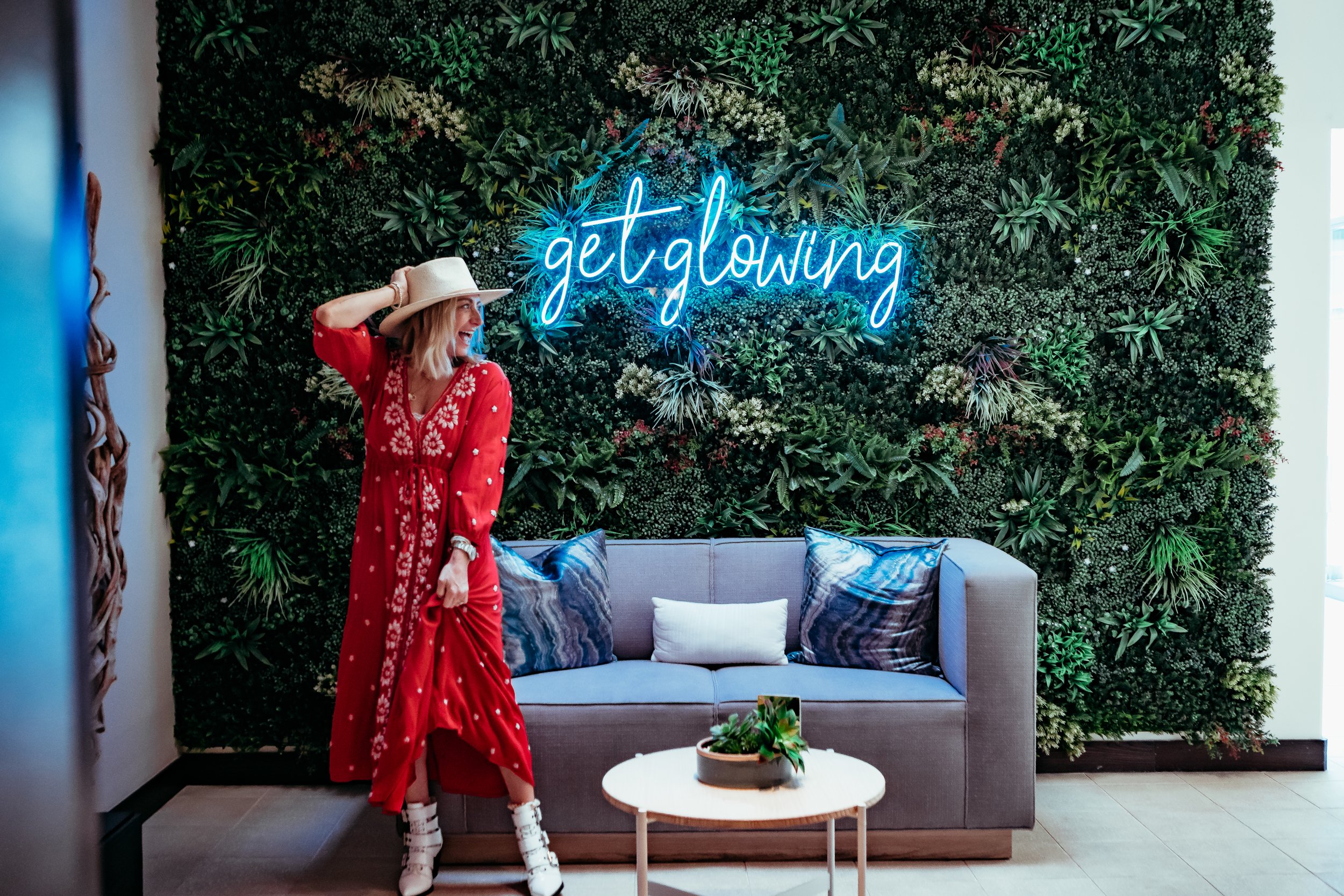 woman standing by neon sign