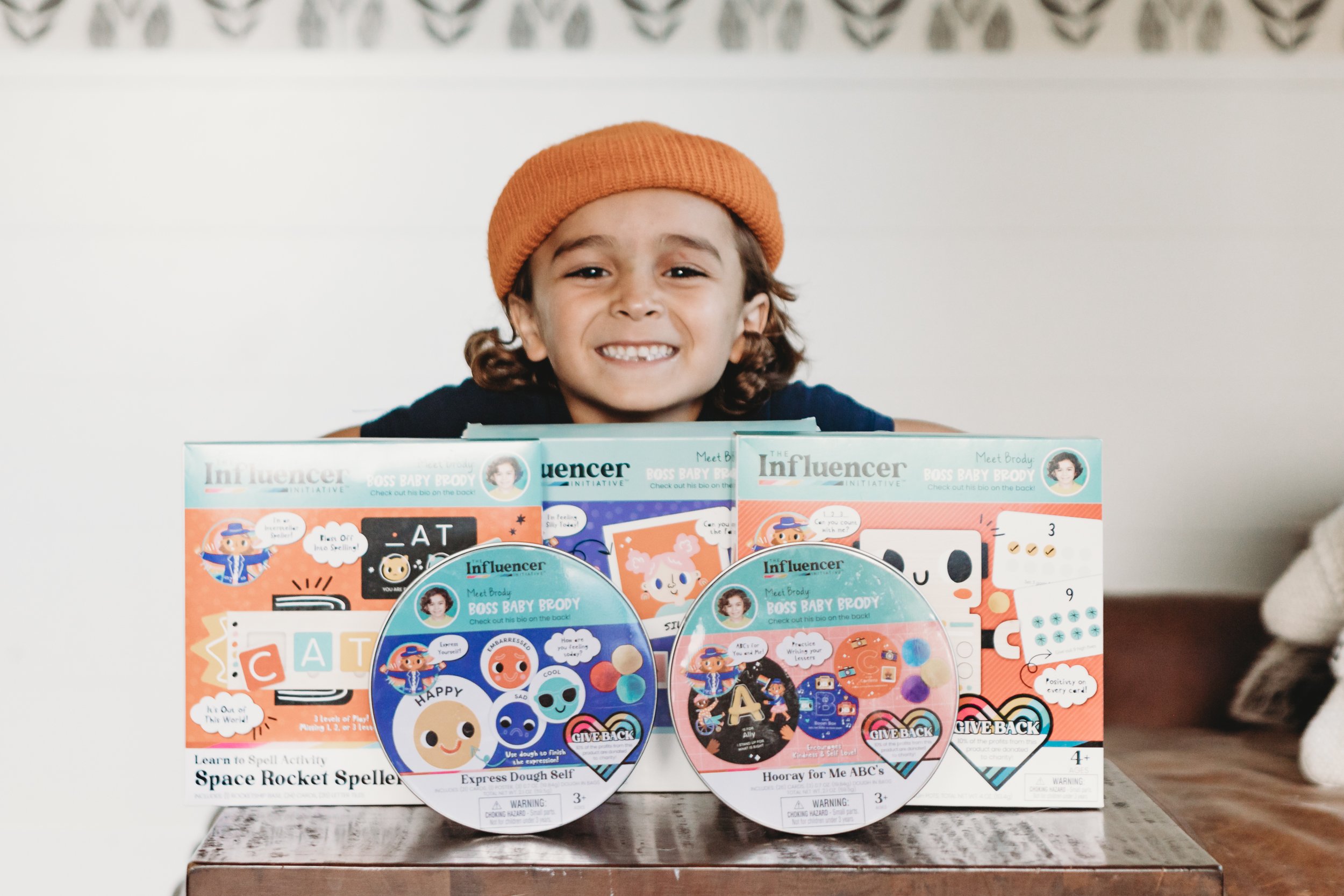 boy smiling with his toys