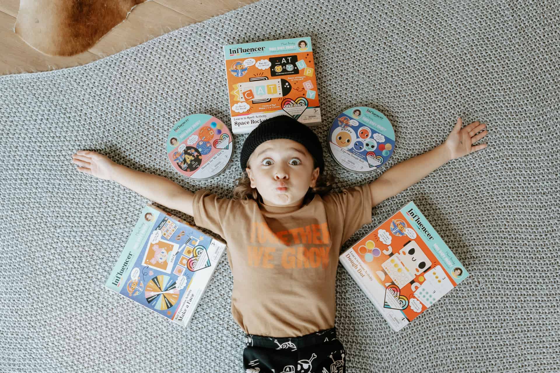 boy on floor with toys