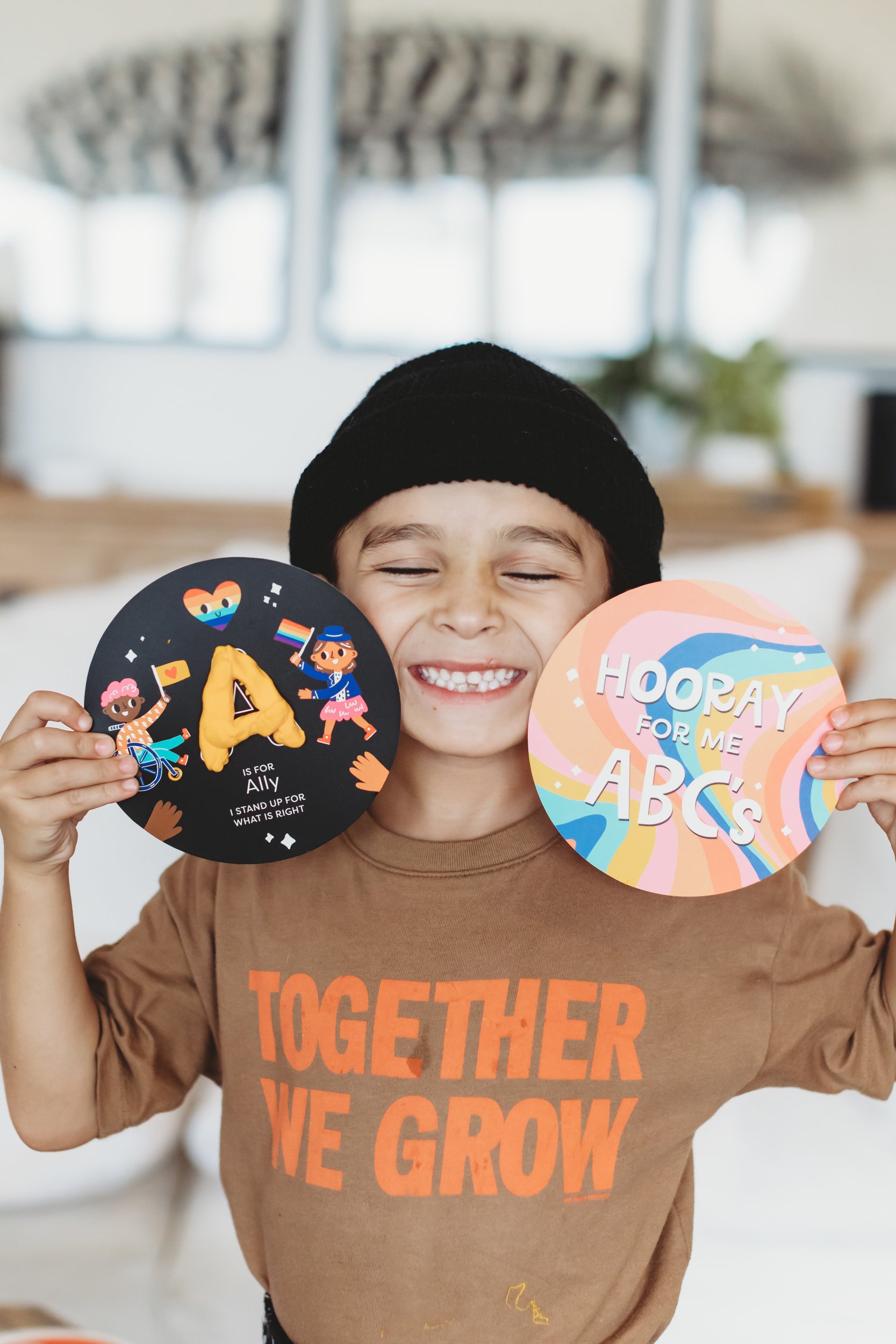 boy smiling holding his toys