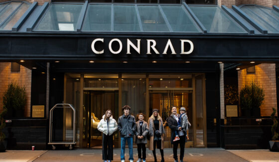 family in front of conrad hotel
