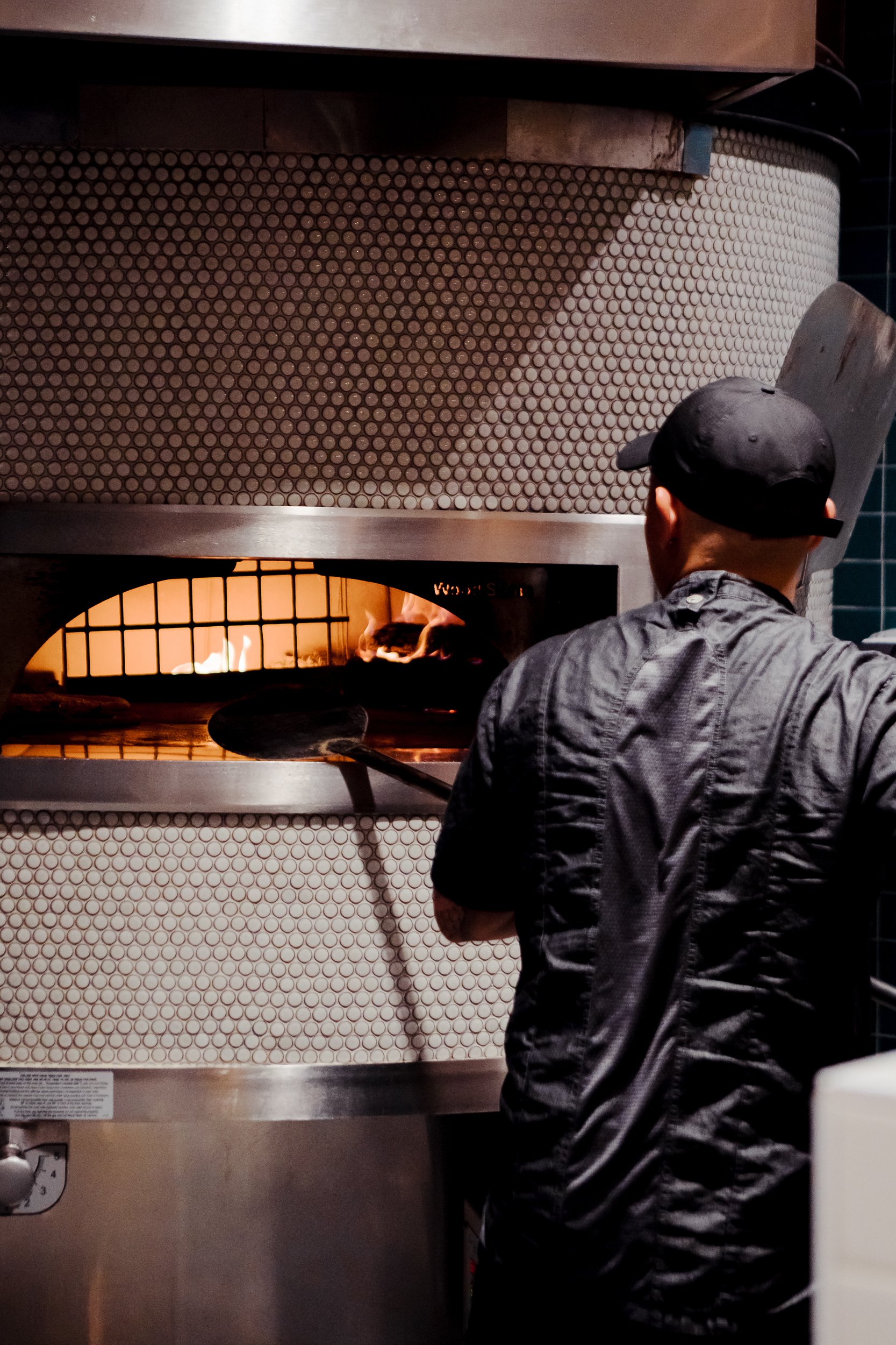 chef making wood fire pizza