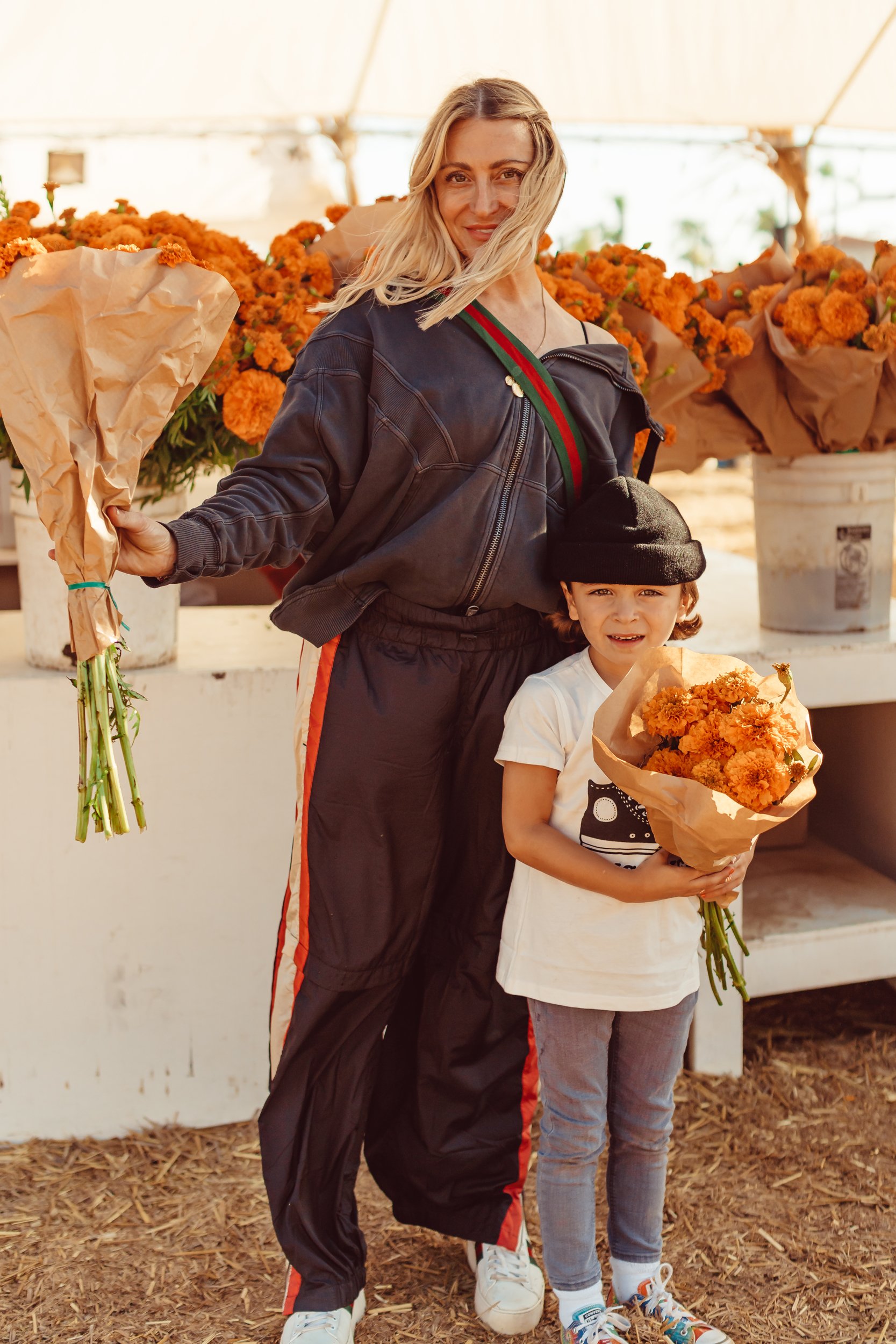 mom and son with flower bouquets