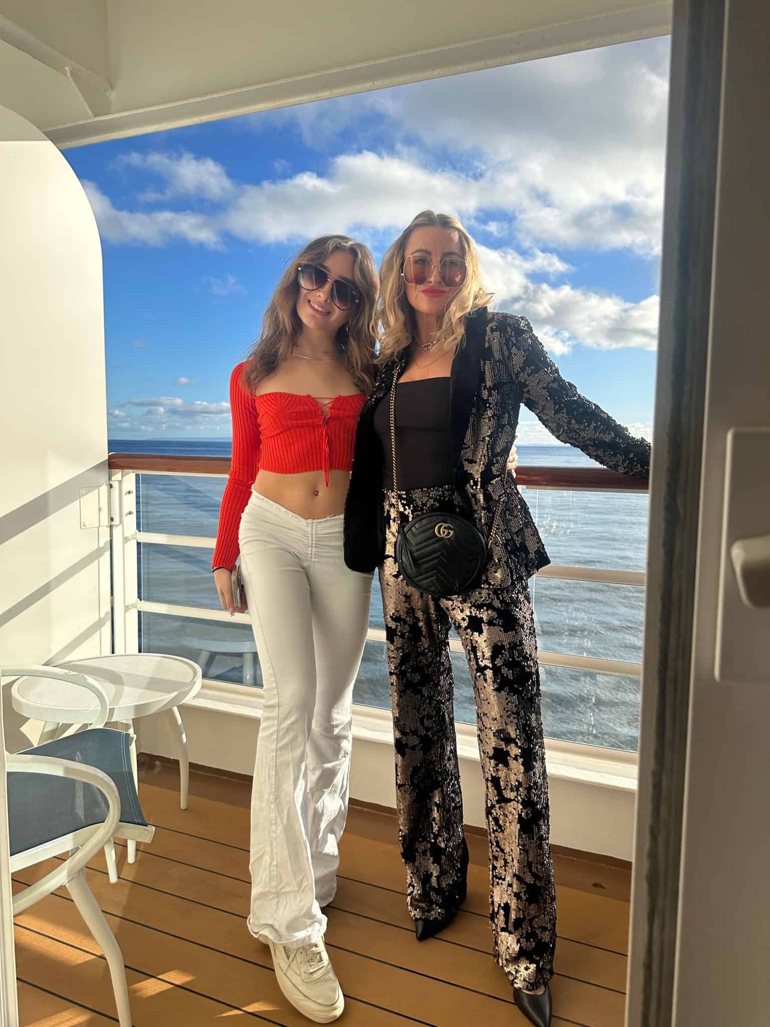 mom and daughter standing on a boat