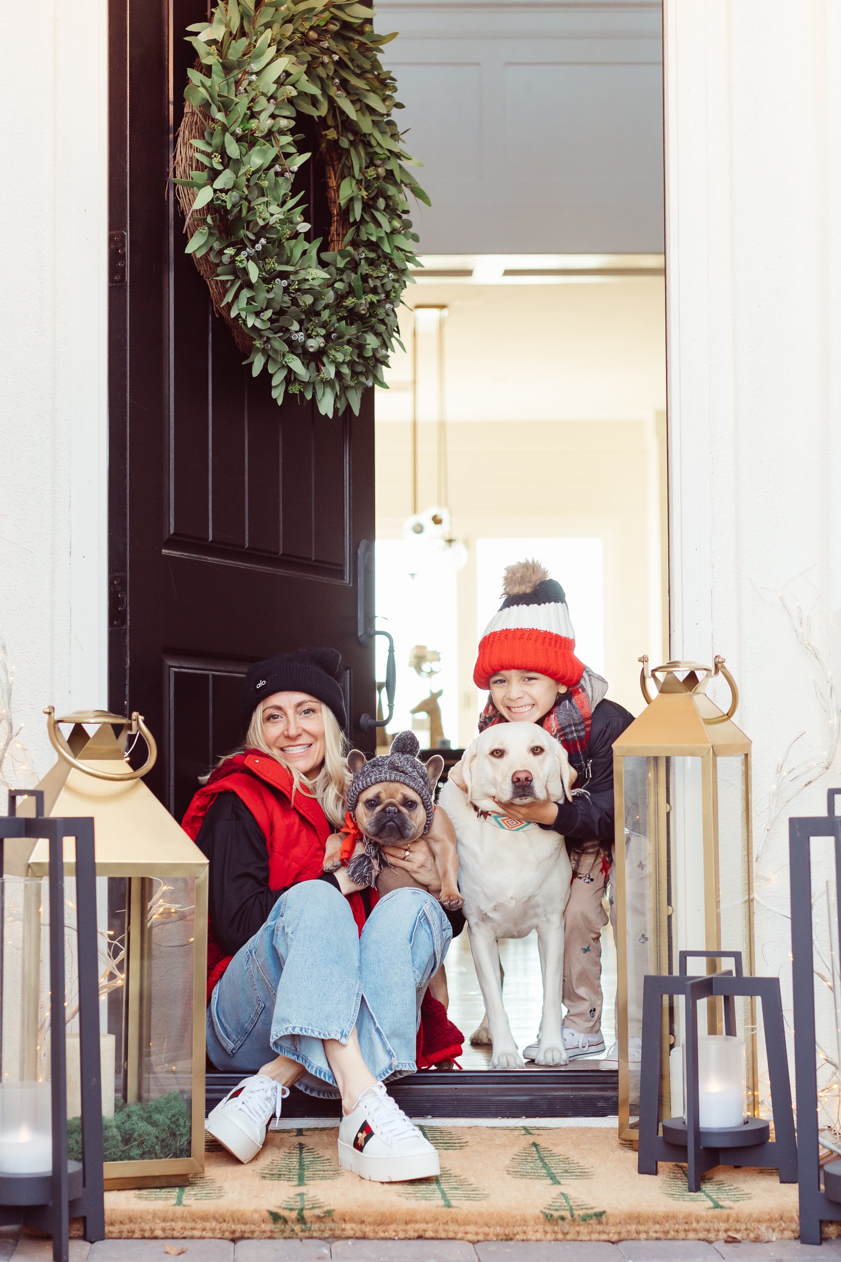 mom and son with dogs sitting in doorway