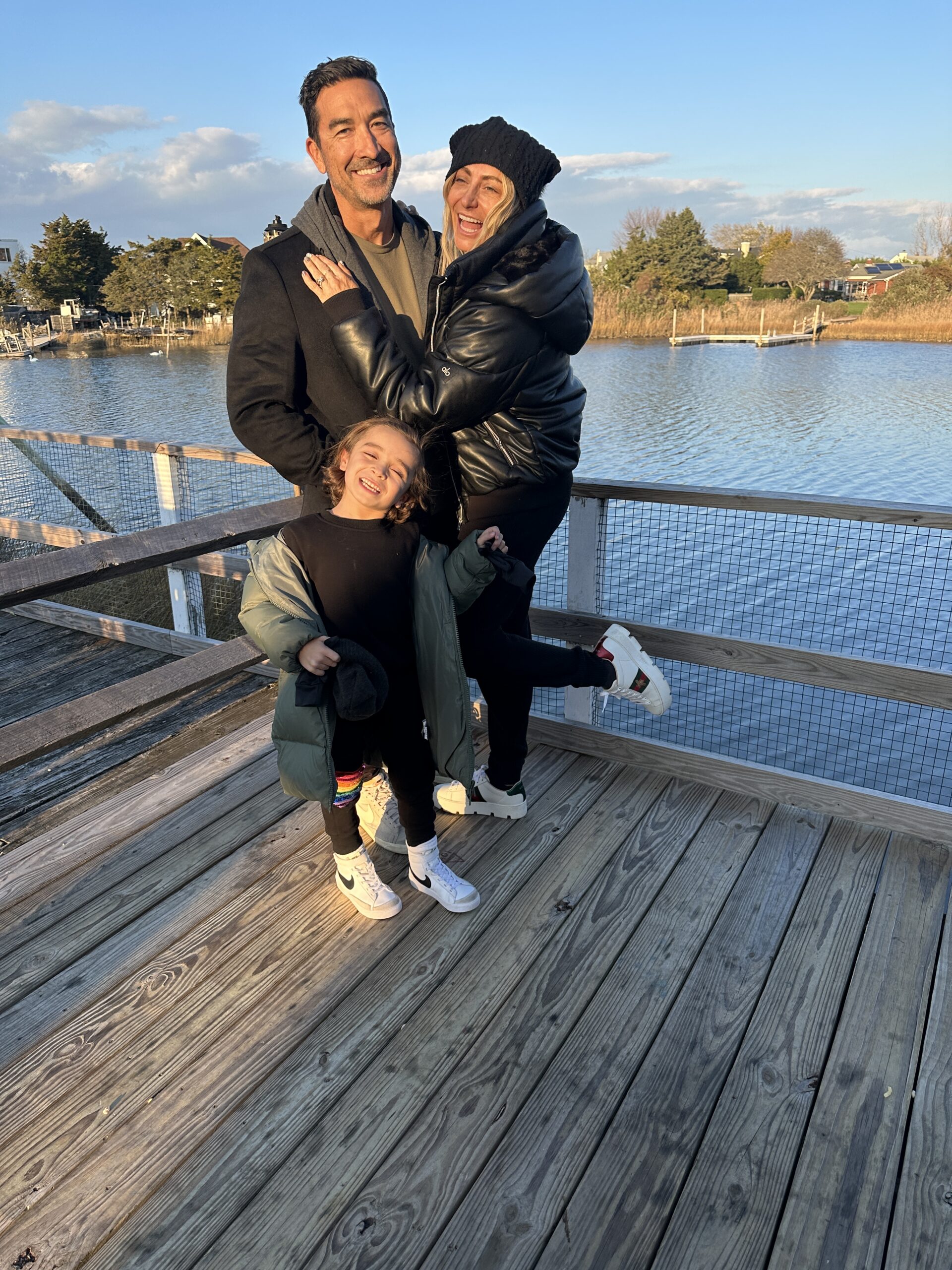 parents with son on pier