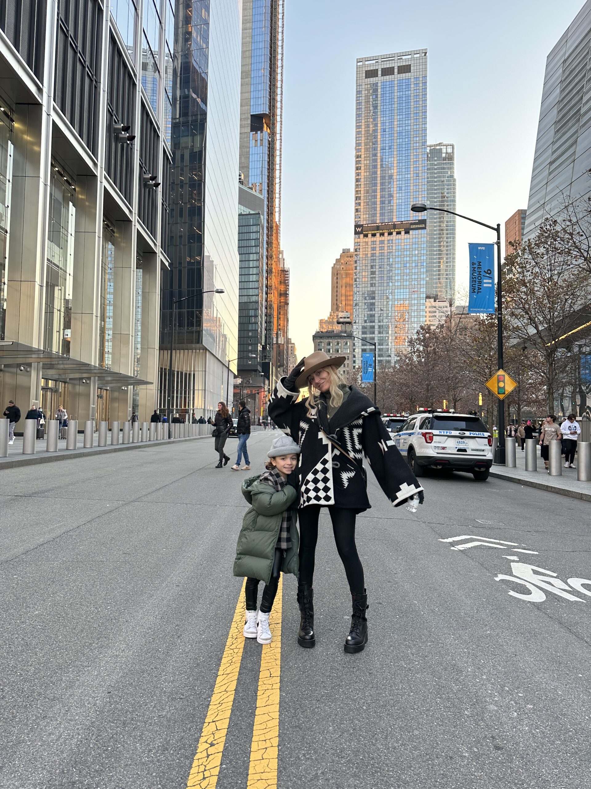 A mom standing on a street in NYC with her young son. 