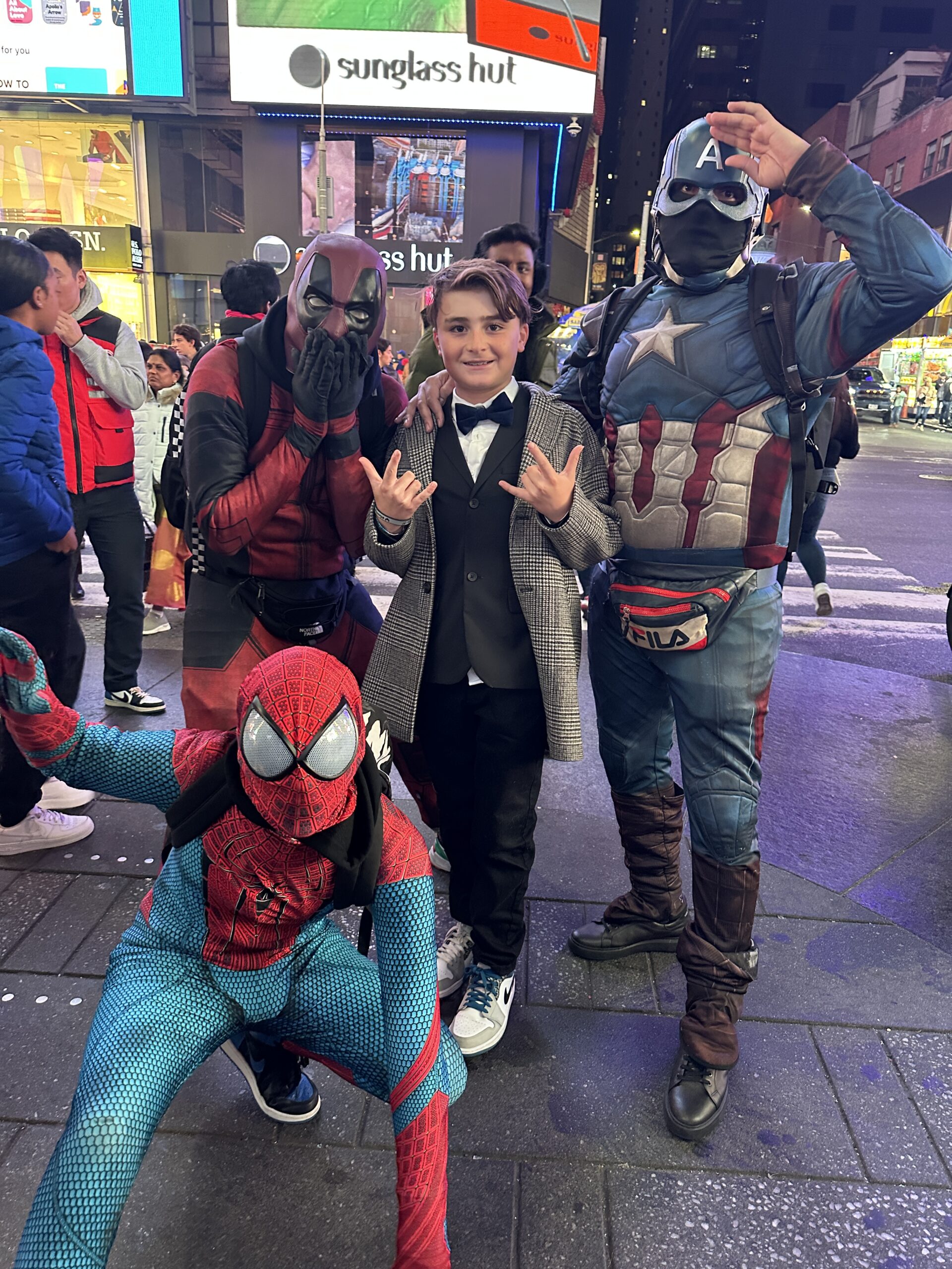 boy with superheros in times square