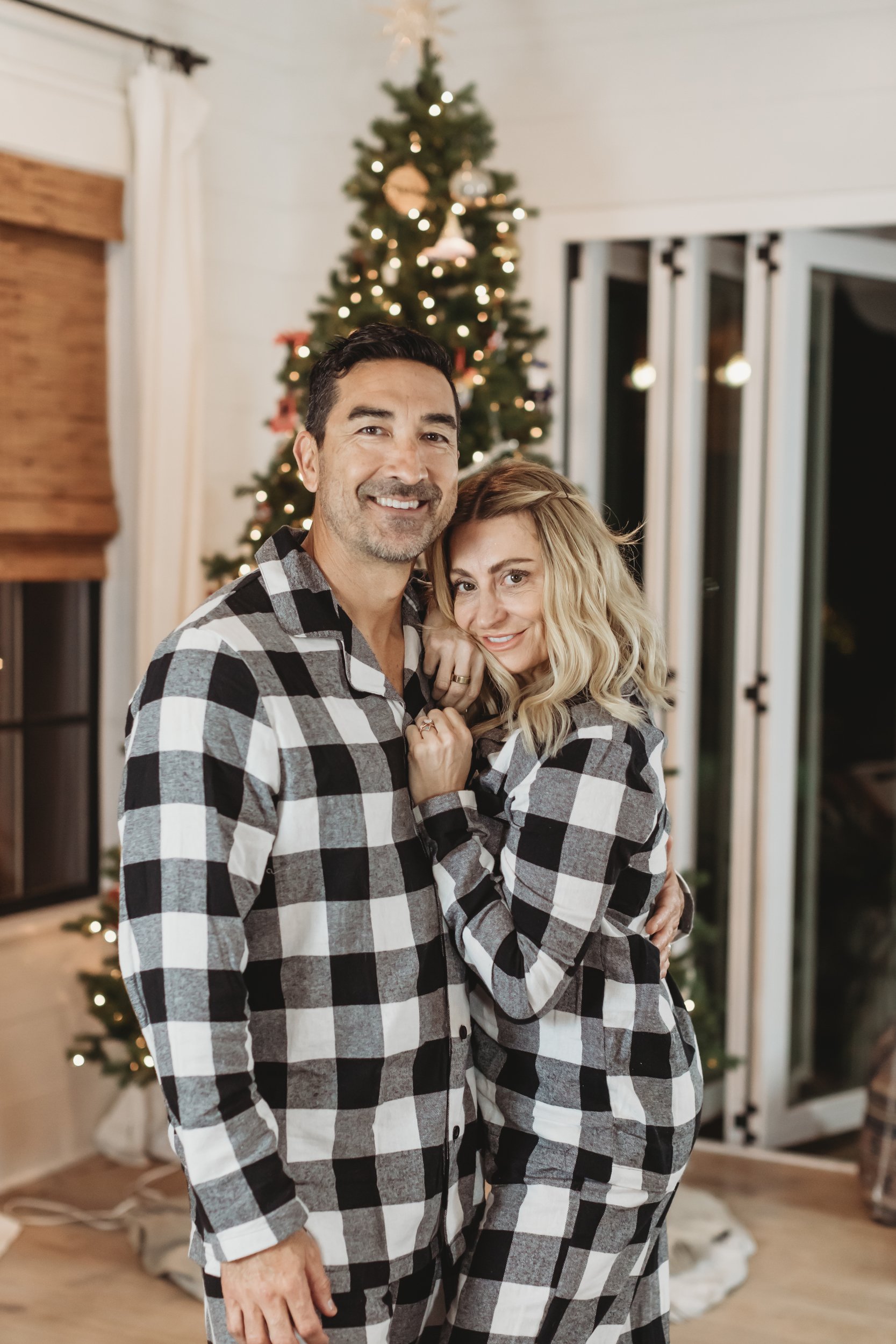 couple hugging by christmas tree