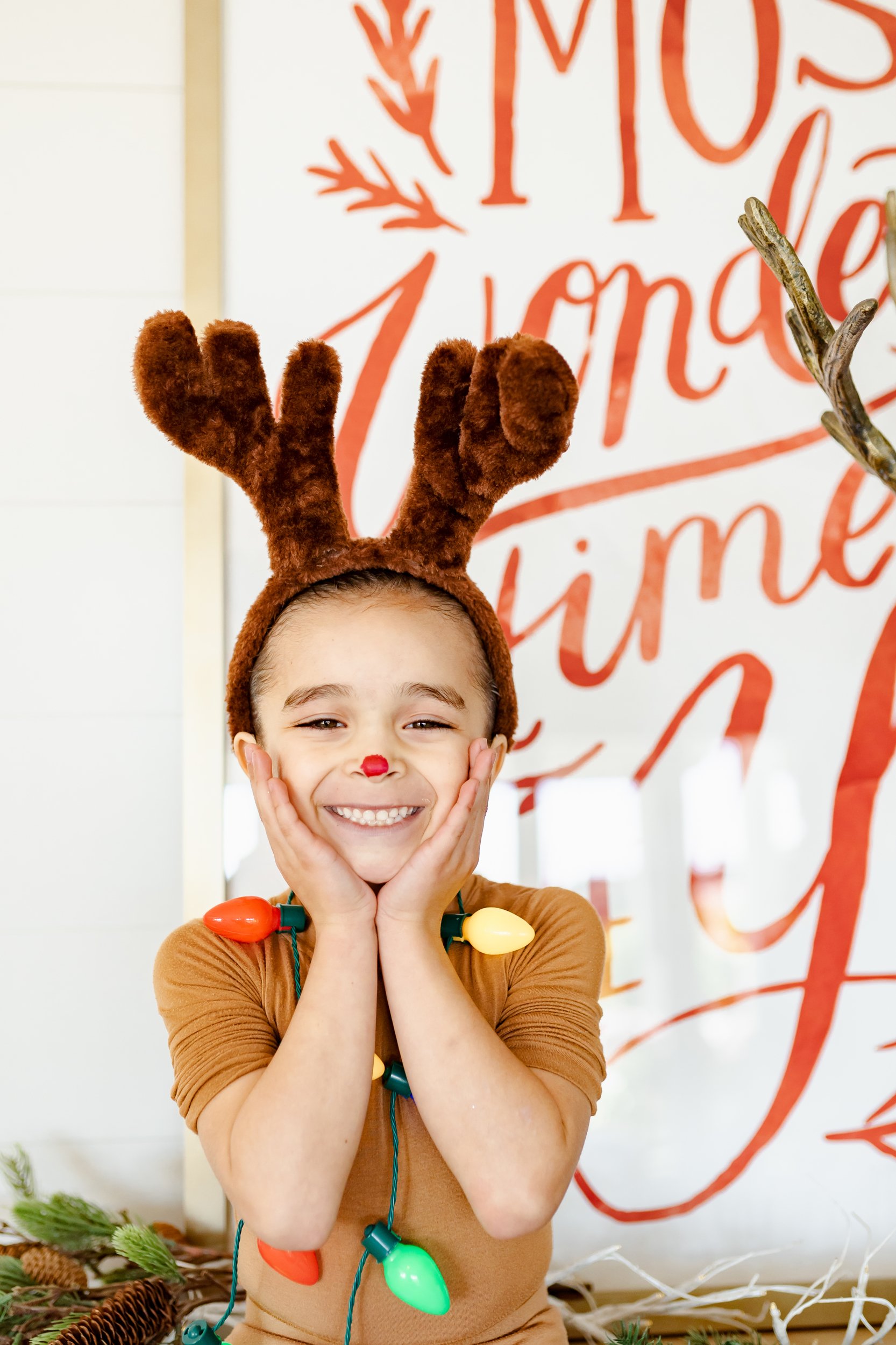 smiling boy dressed as reindeer 