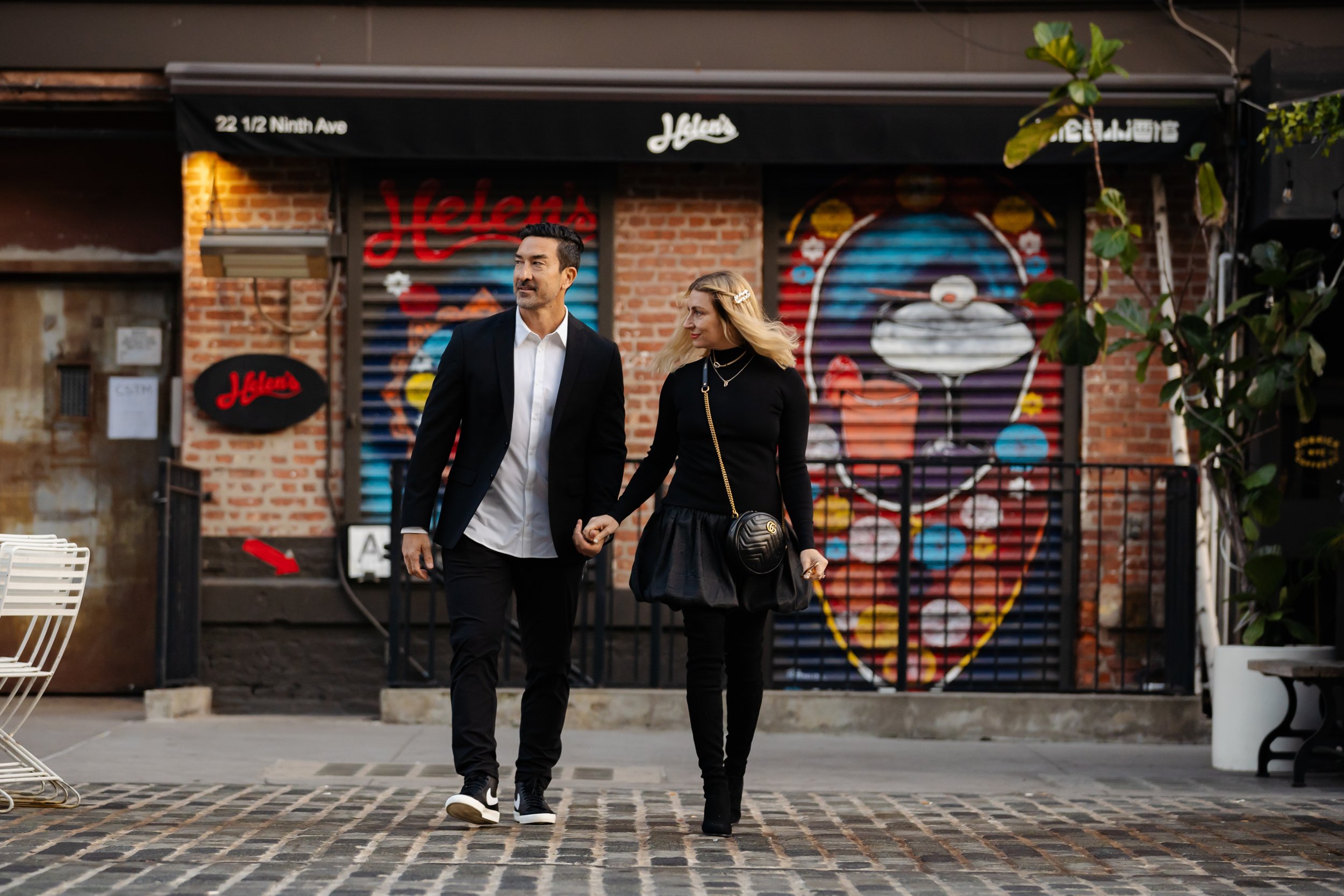 A couple walks across the street in New York City.