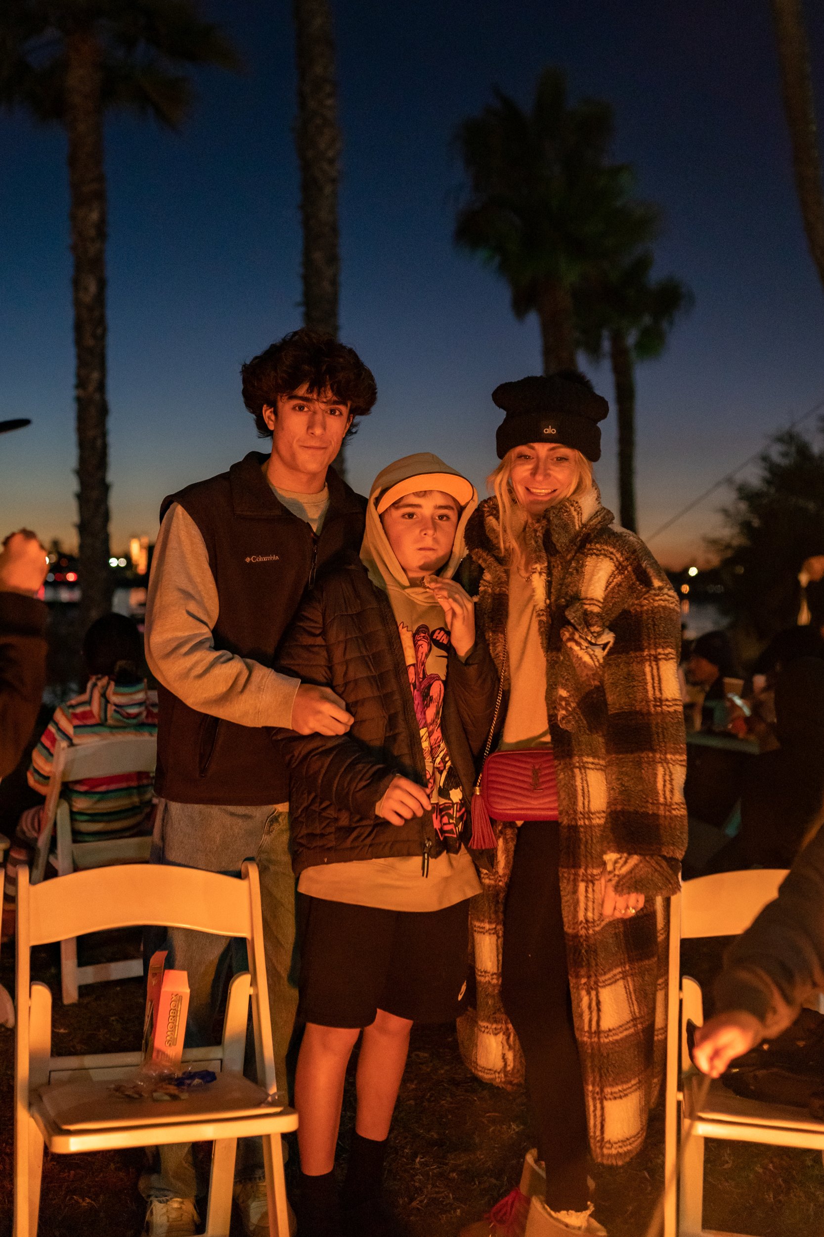 mom and sons around campfire