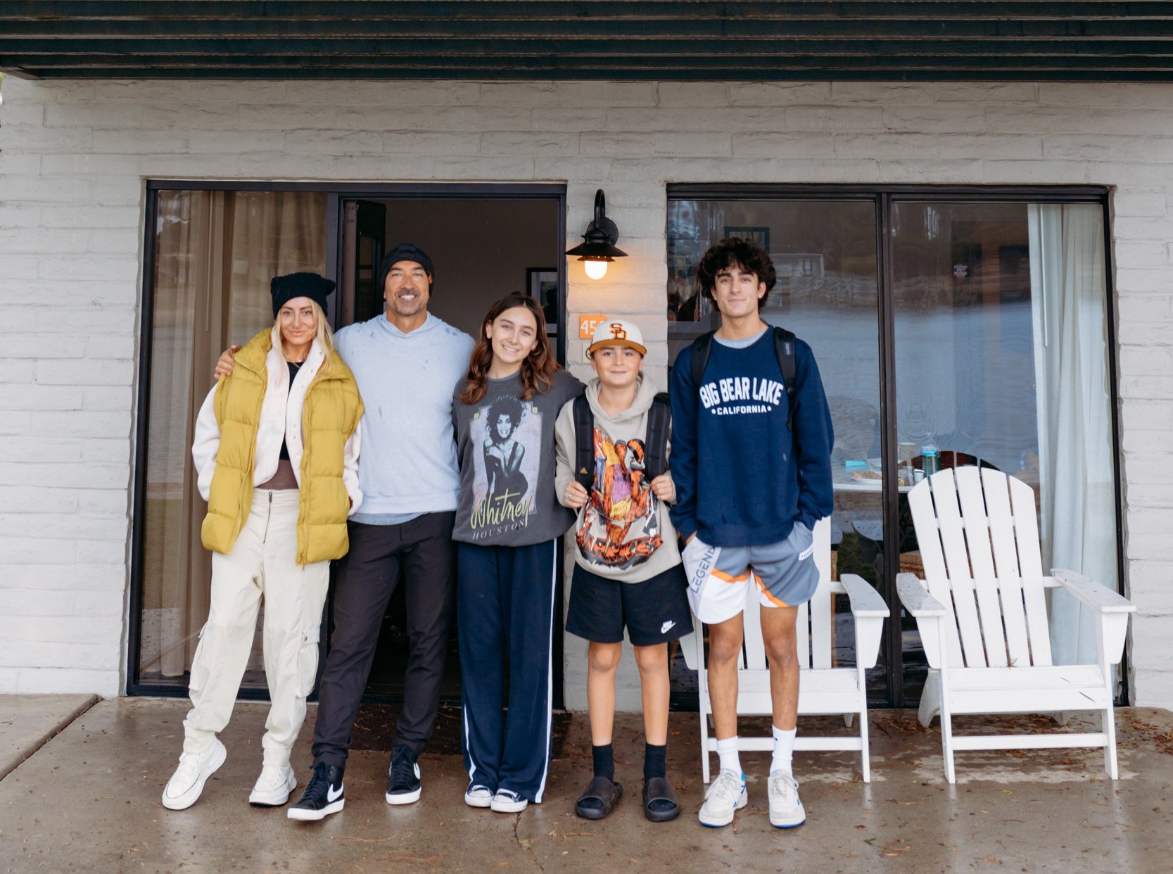 A family stands outside together at their vacation rental.