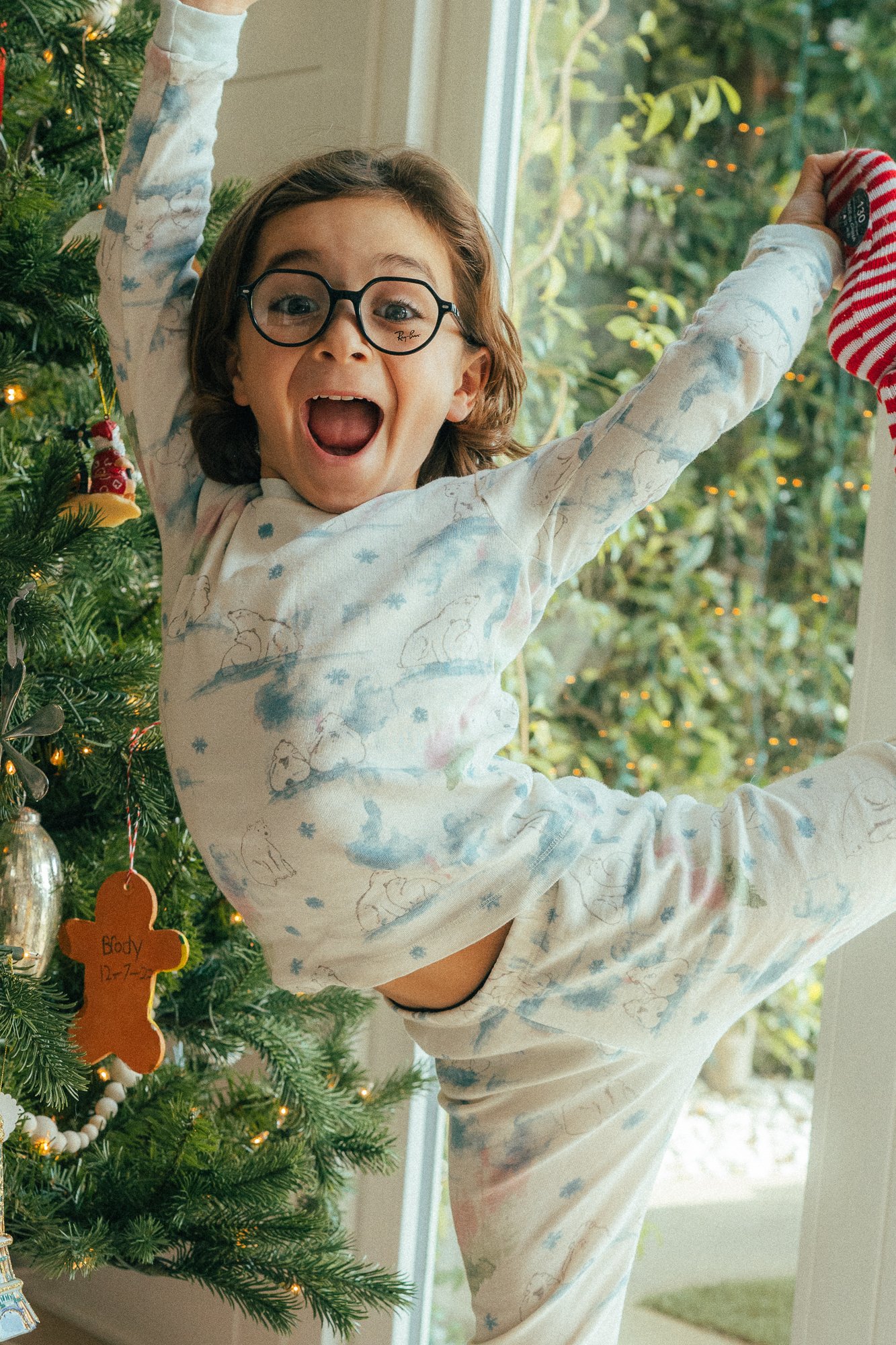 boy dancing by christmas tree