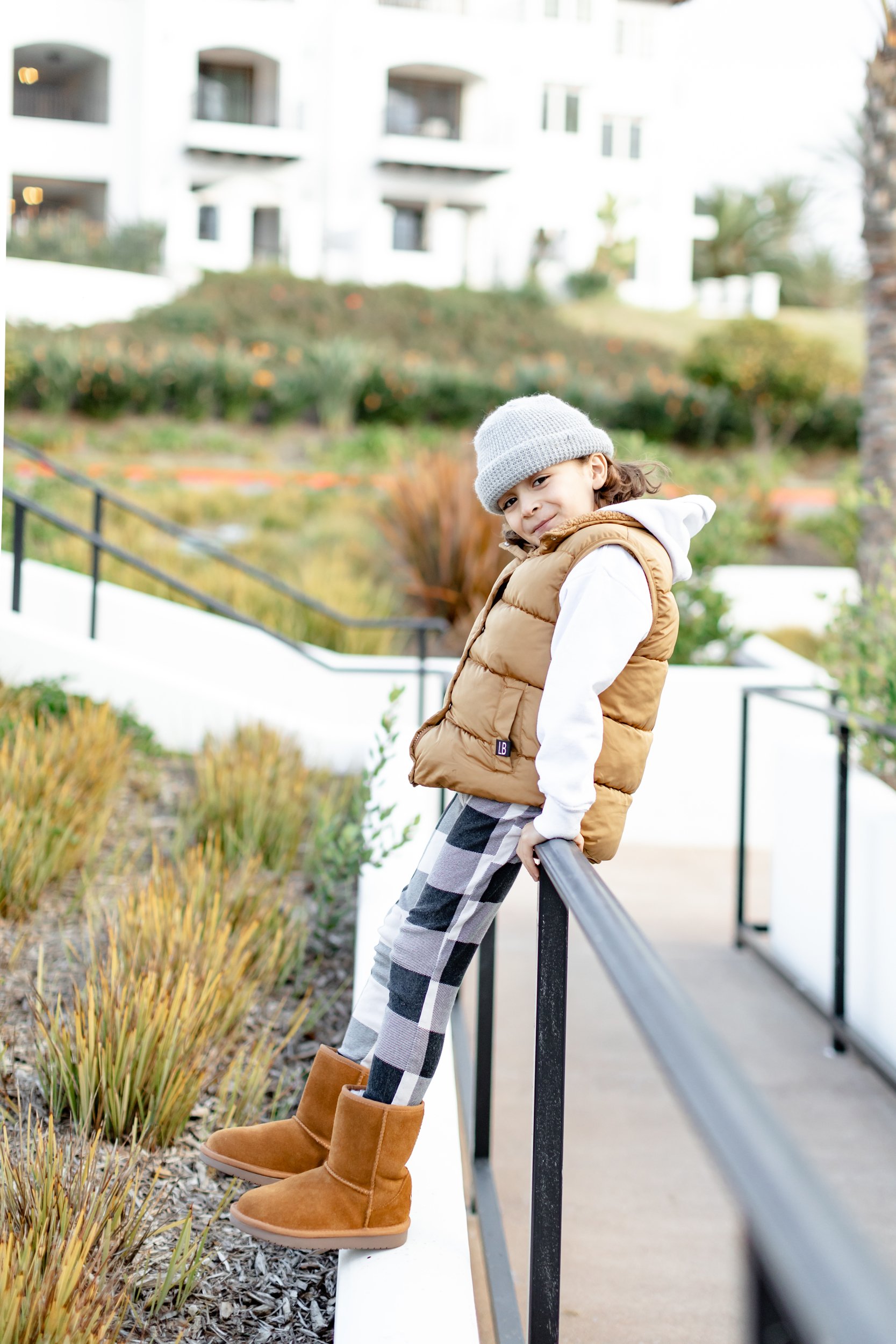 boy sitting on rail