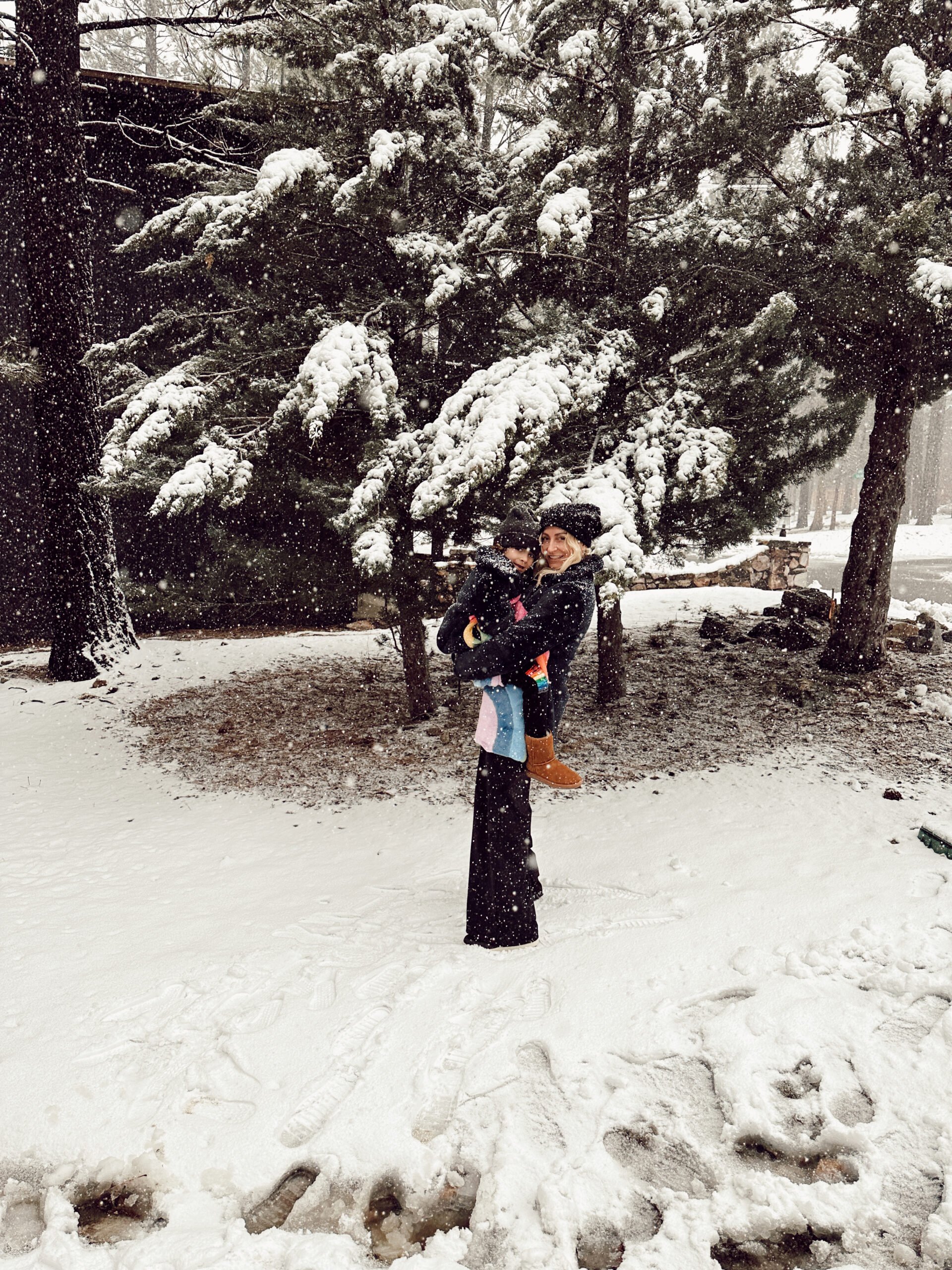 mom holding son in the snow