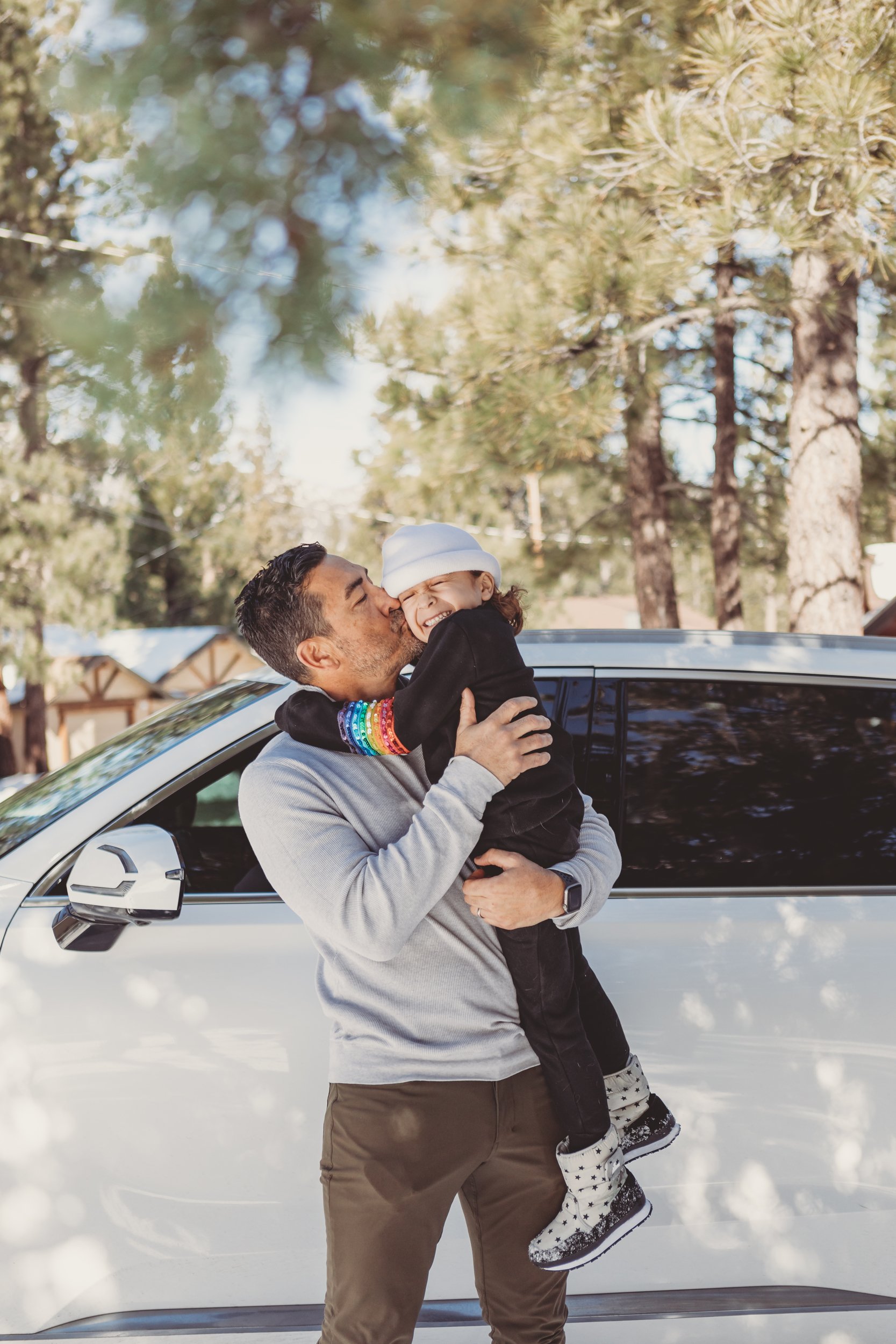 dad kissing his son