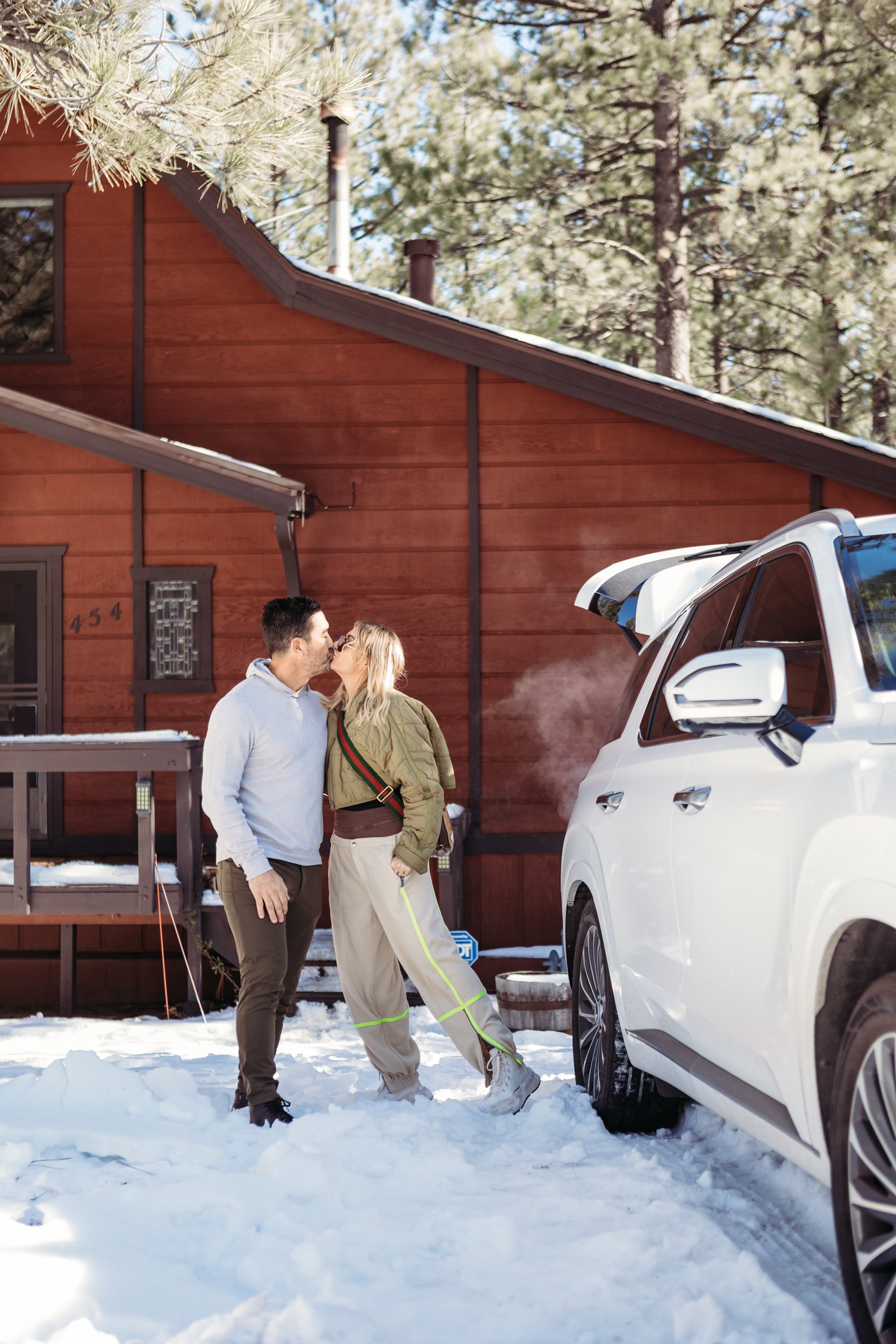 couple kissing at winter cabin