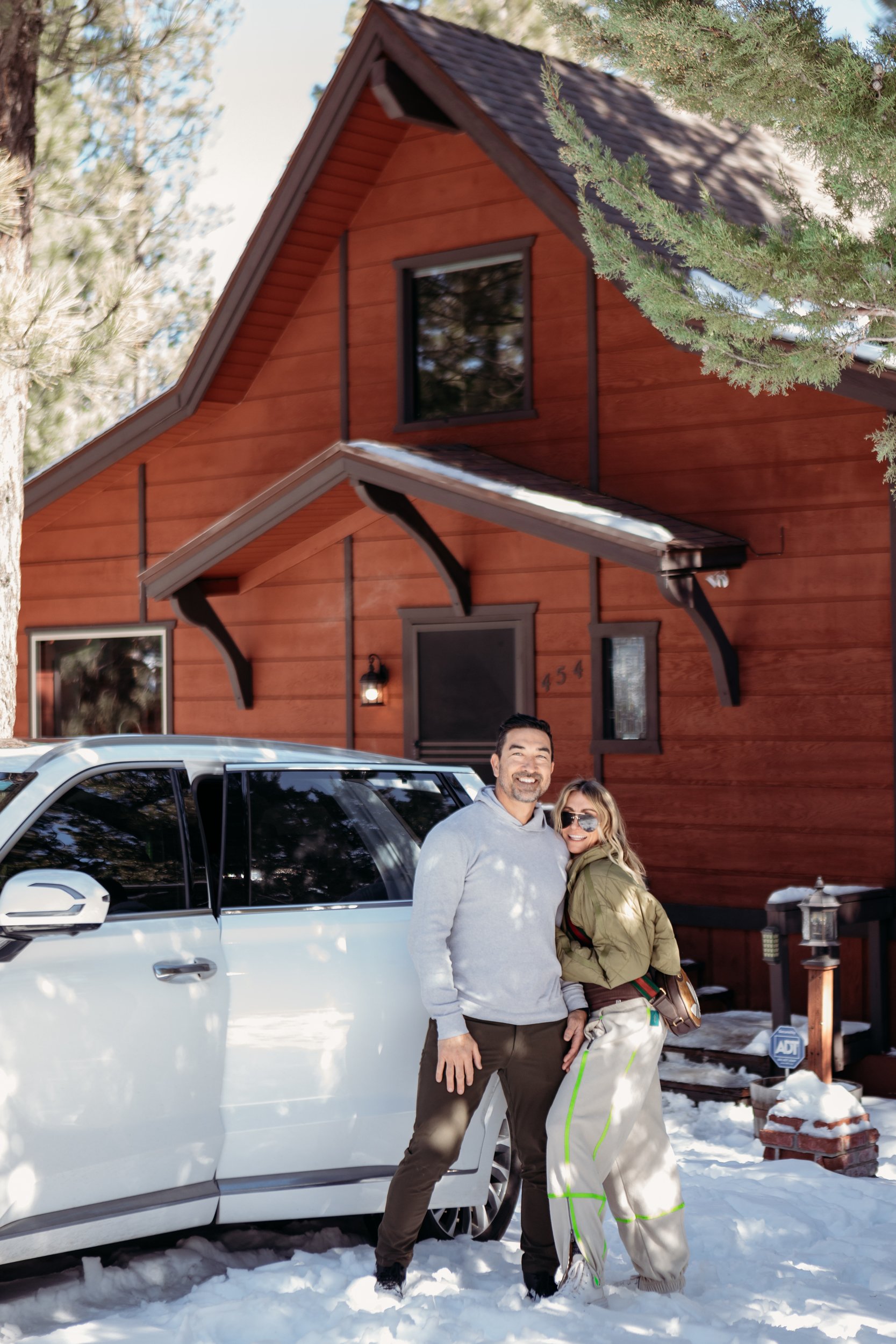 couple hugging outside of cabin