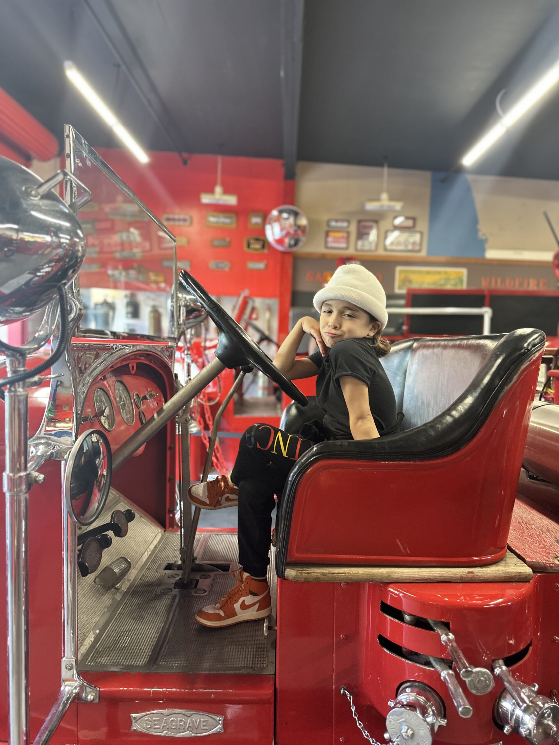 boy in firetruck at Firehouse Museum in Little Italy, San Diego