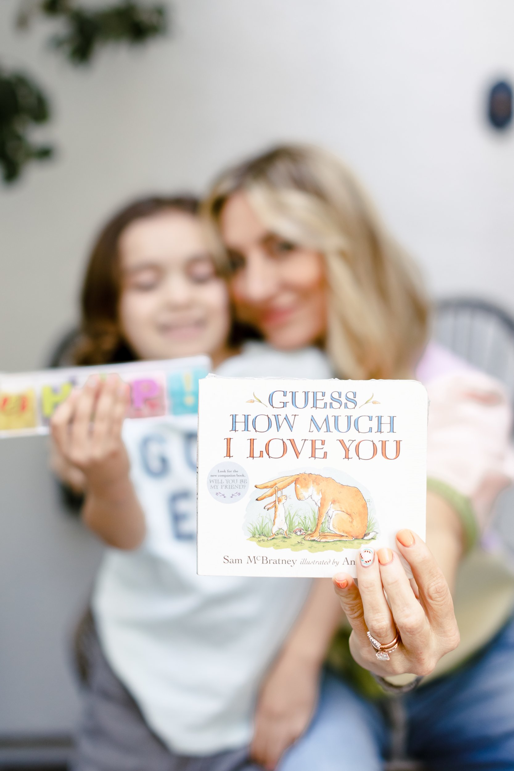 mom and son holding book