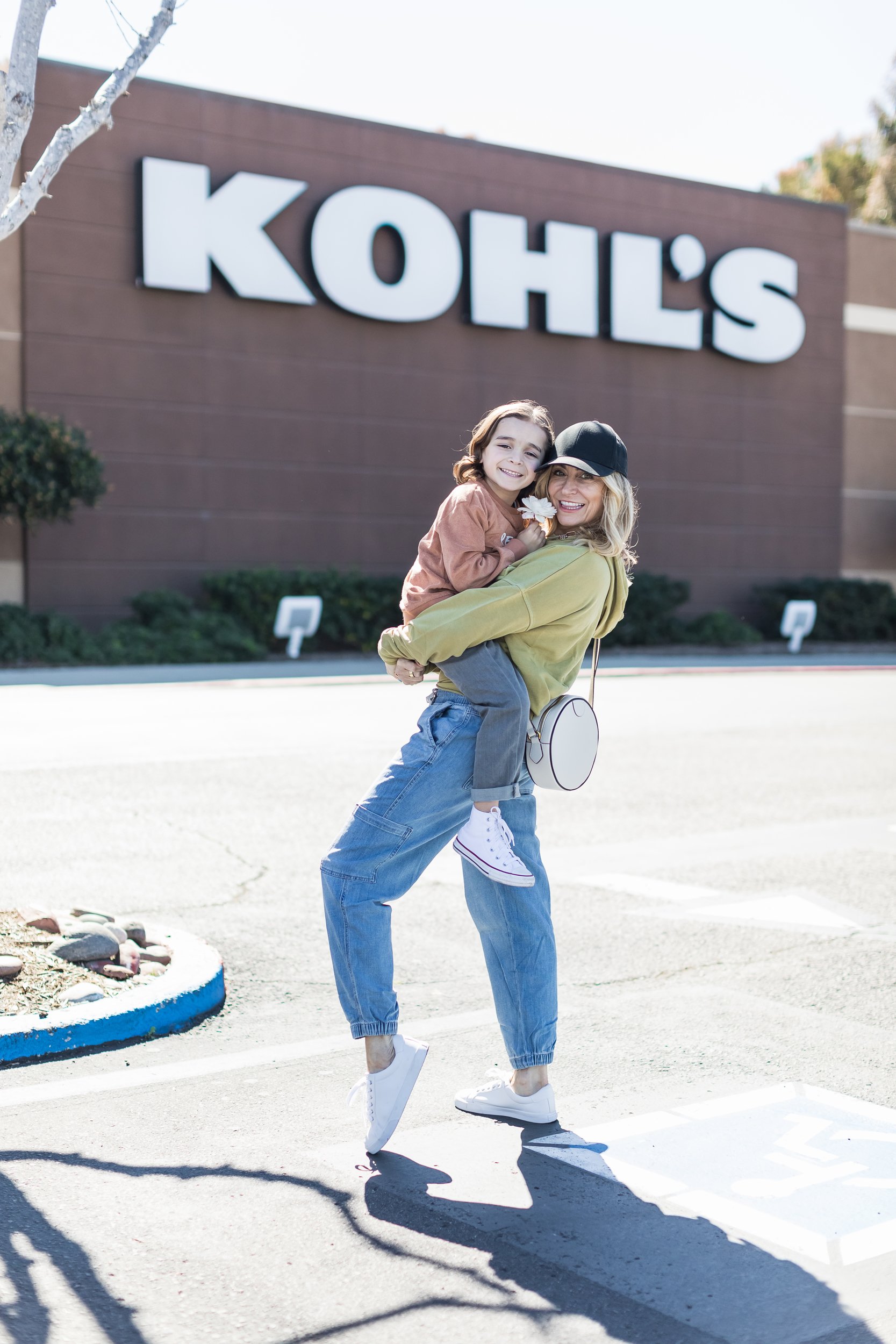 mom holding her son in store parking lot