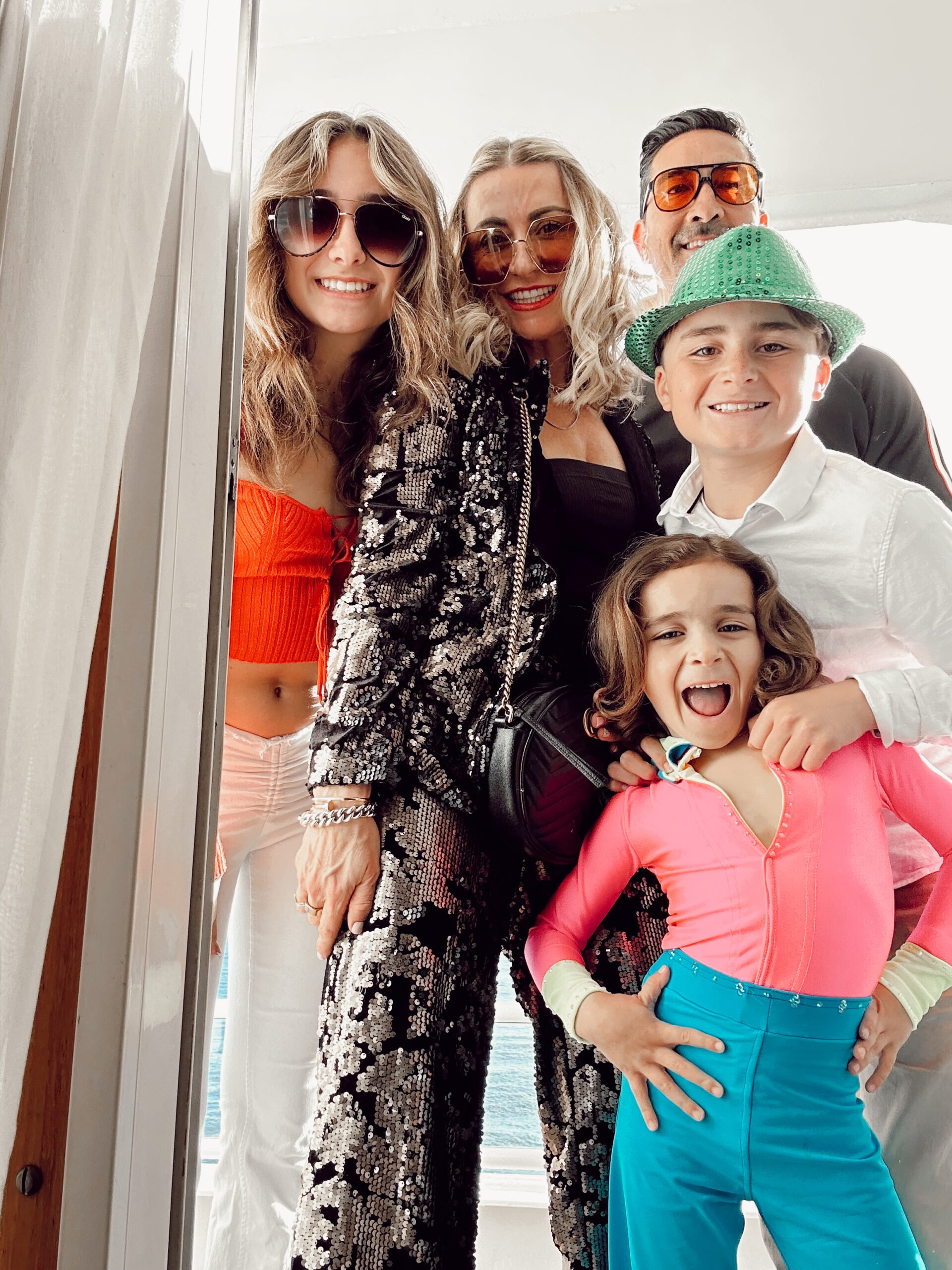 A family in bright party clothes is ready to go dancing.