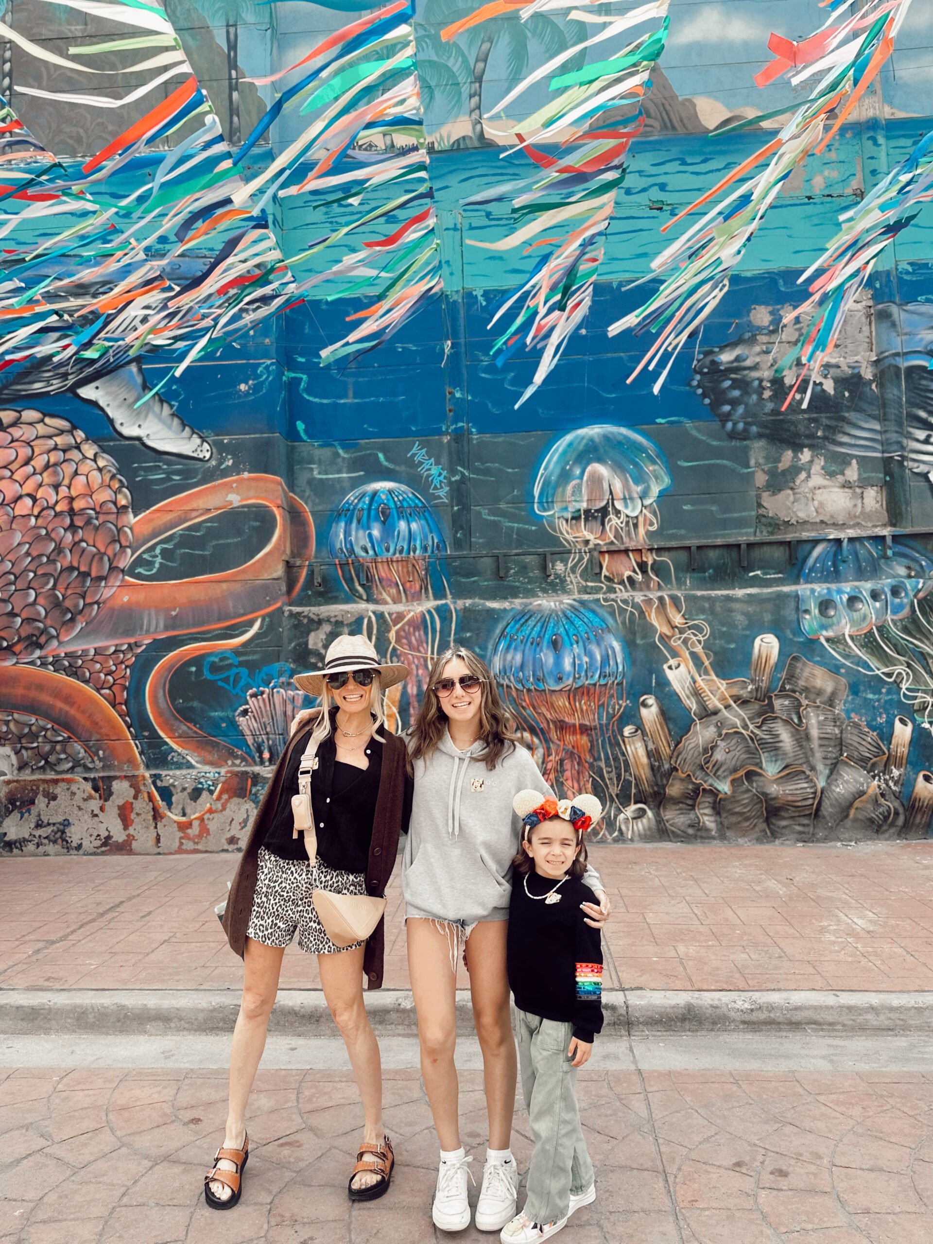 mom with kids in front of mural