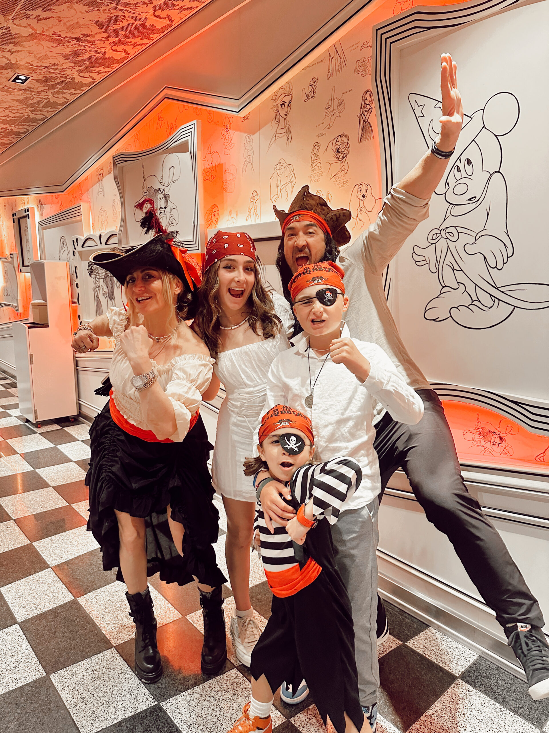 A family dressed up like pirates on the Disney Cruise line.