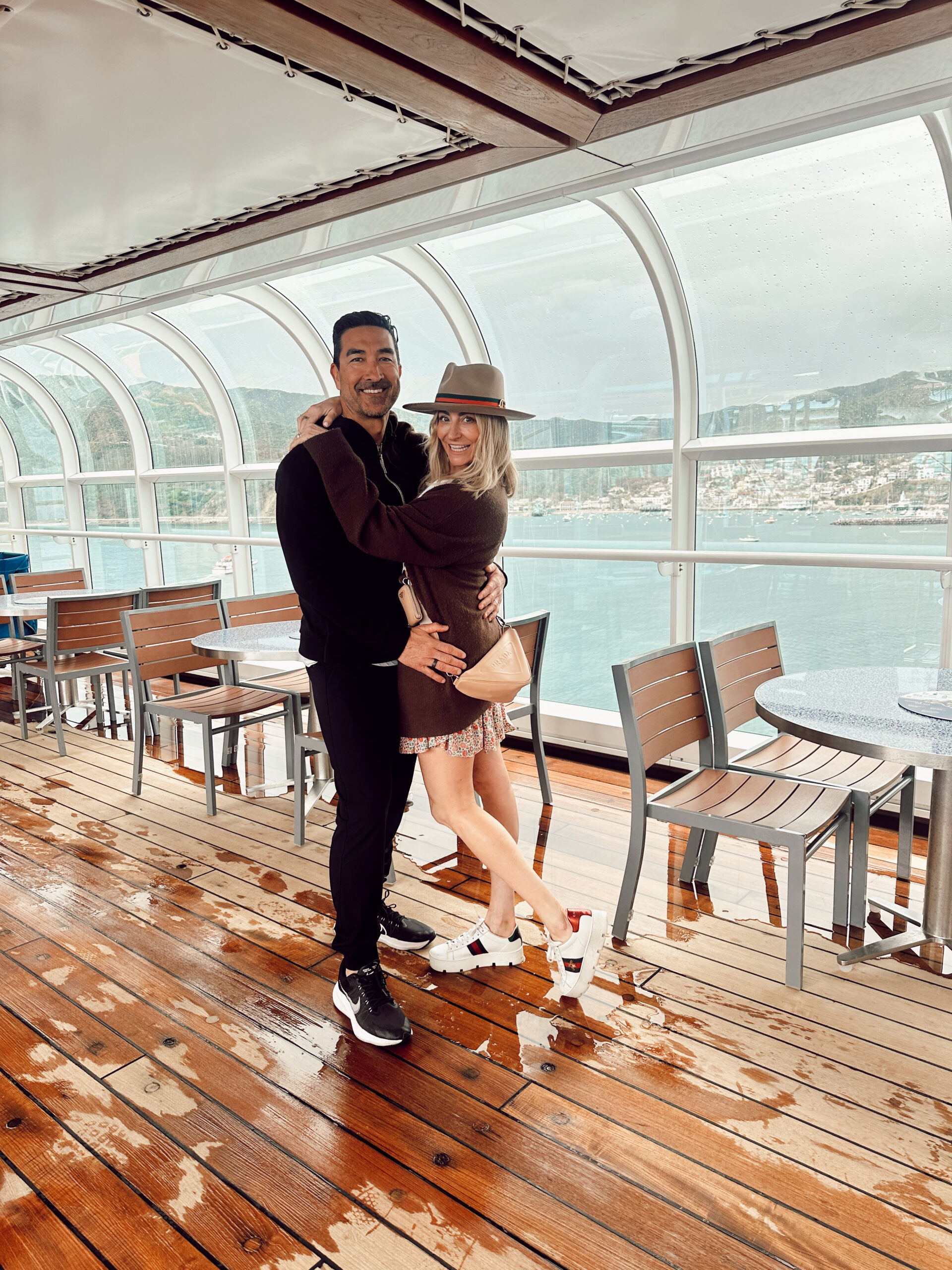 A couple hugging on the deck of a ship.