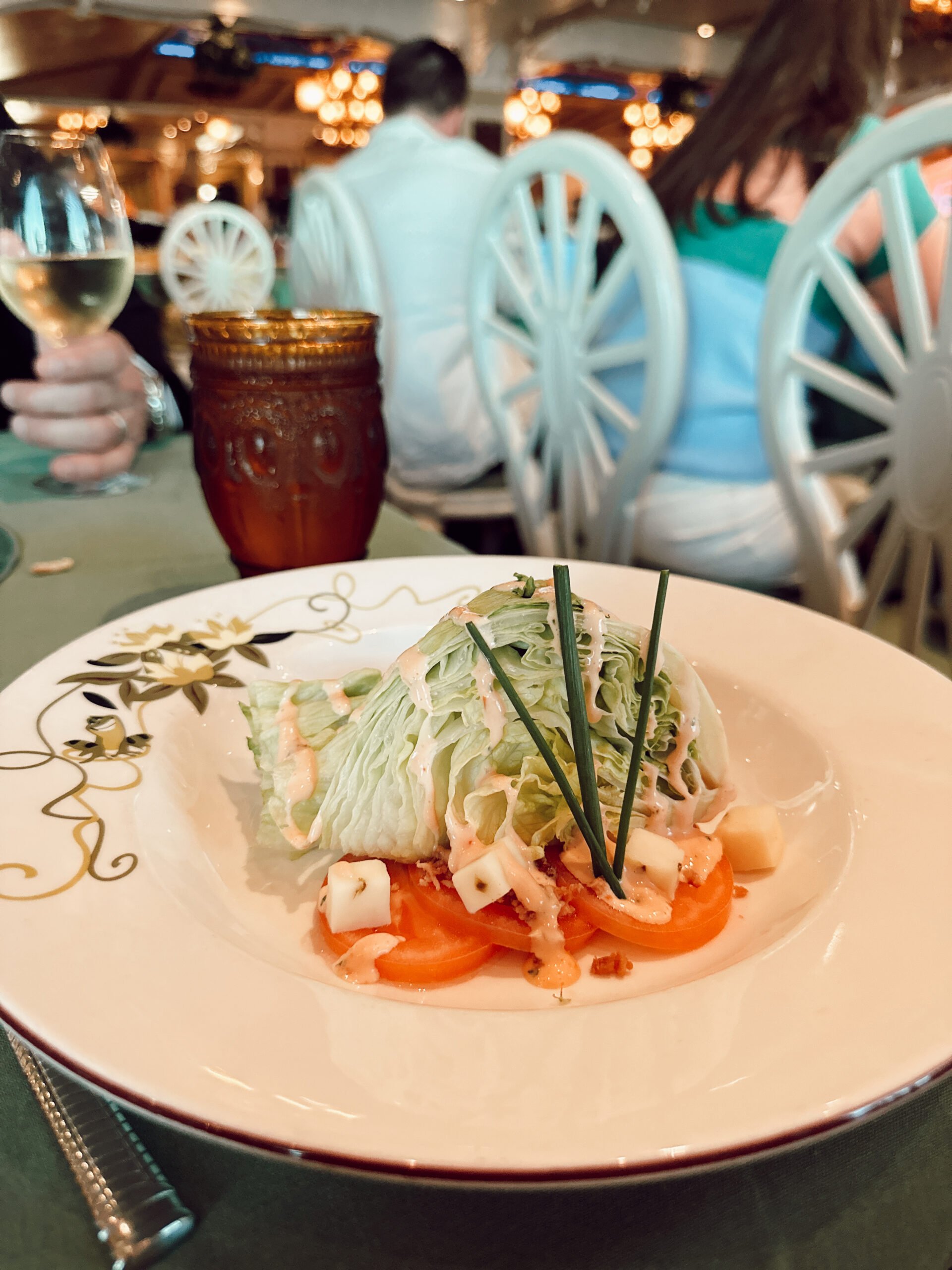 An iceberg salad on a plate on a restaurant table.