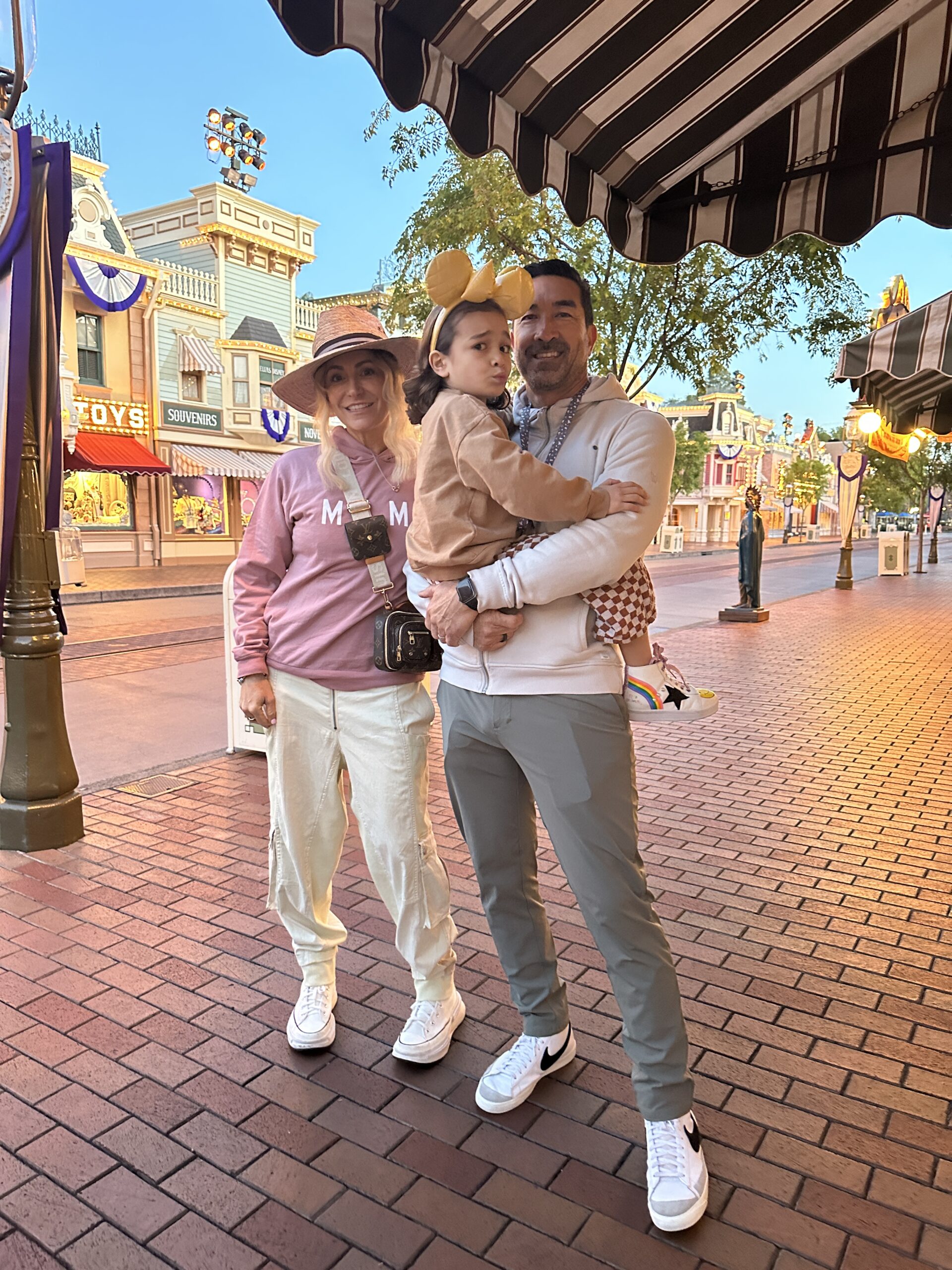 parents holding their son at disneyland