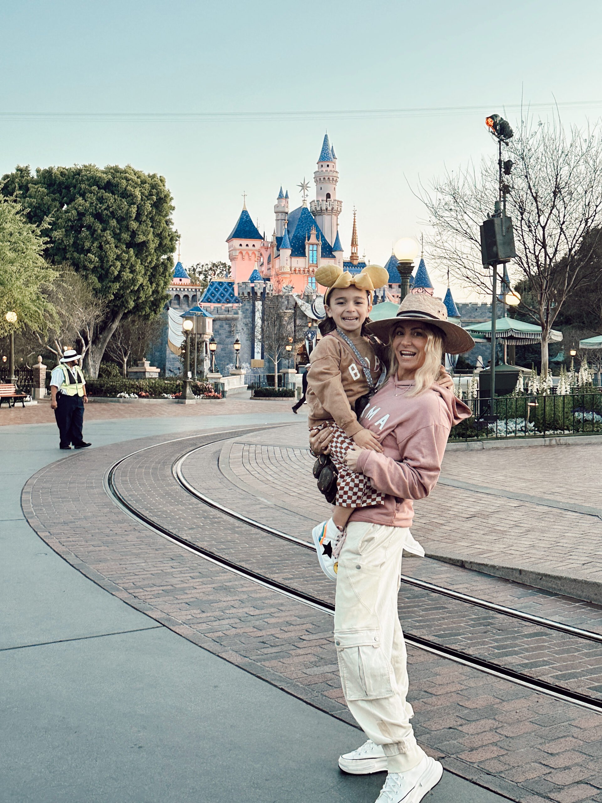 mom holding son at disneyland