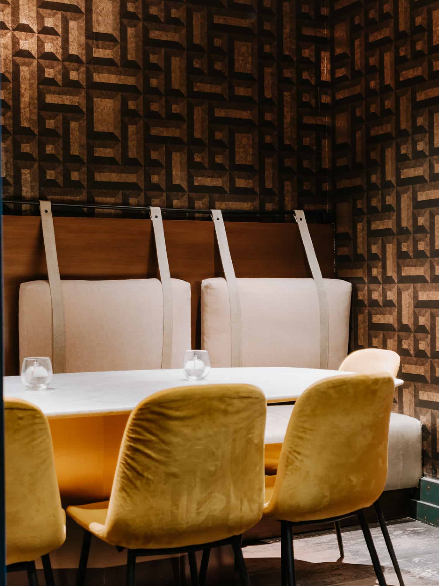 A cozy booth with plush velvet seating inside of The Franklin Mortgage & Investment Company Bar, located within The Franklin on Rittenhouse in Philadelphia.
