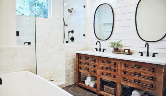 A large modern farmhouse bathroom in neutrals with black fixtures.