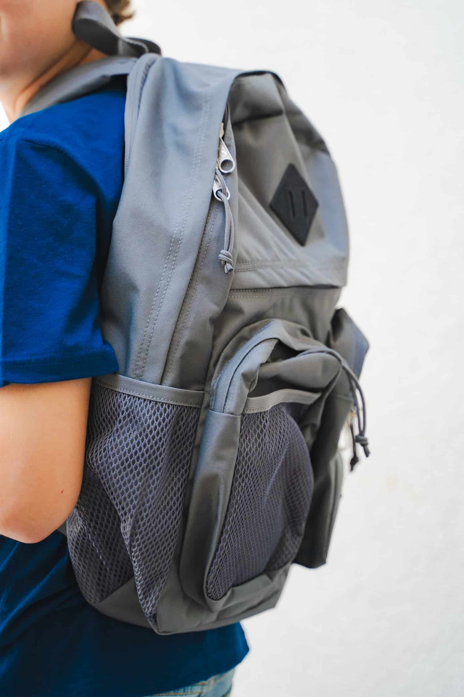 Up close side view of grey backpack.