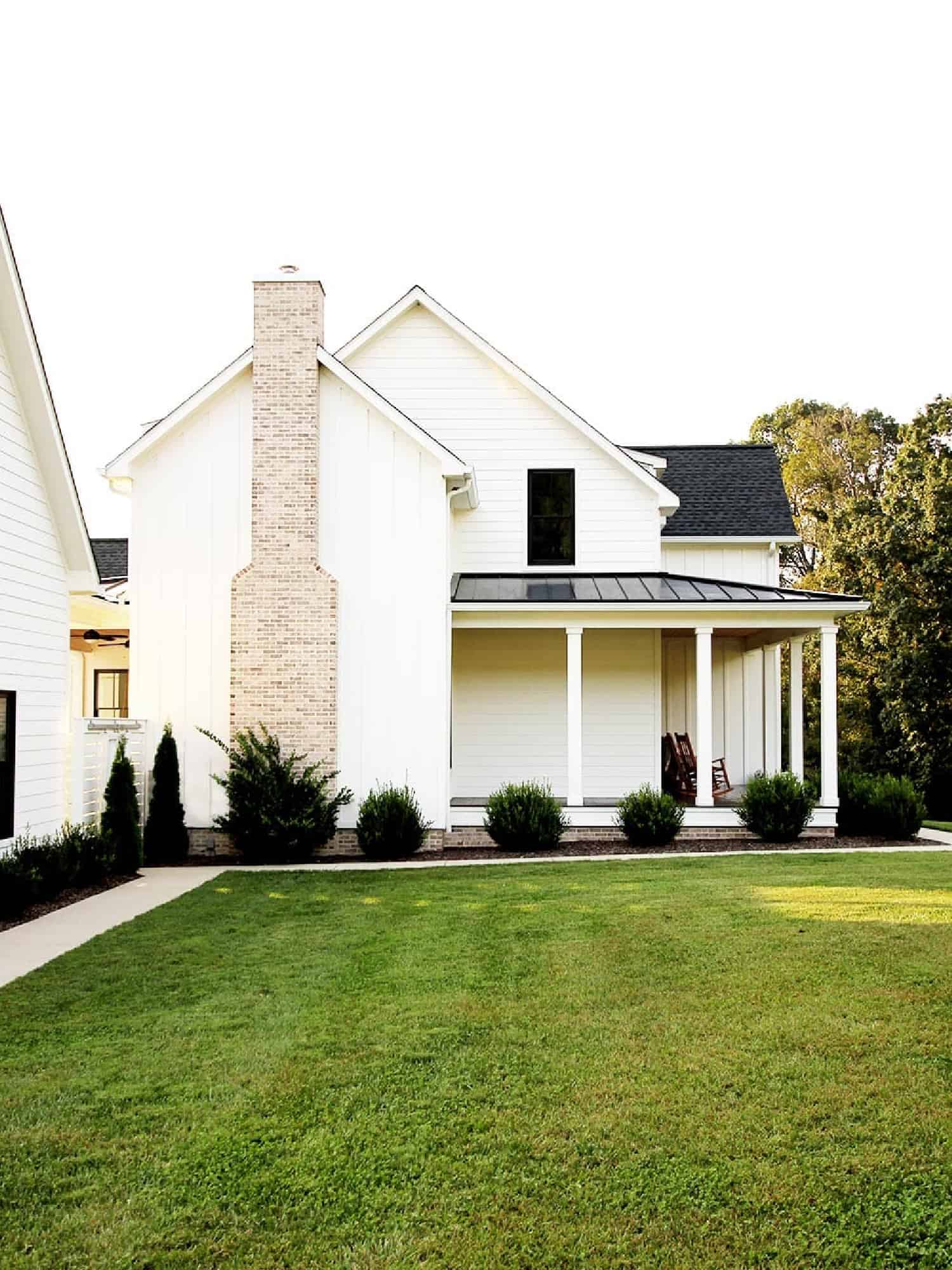 Sideview of a large white farmhouse.