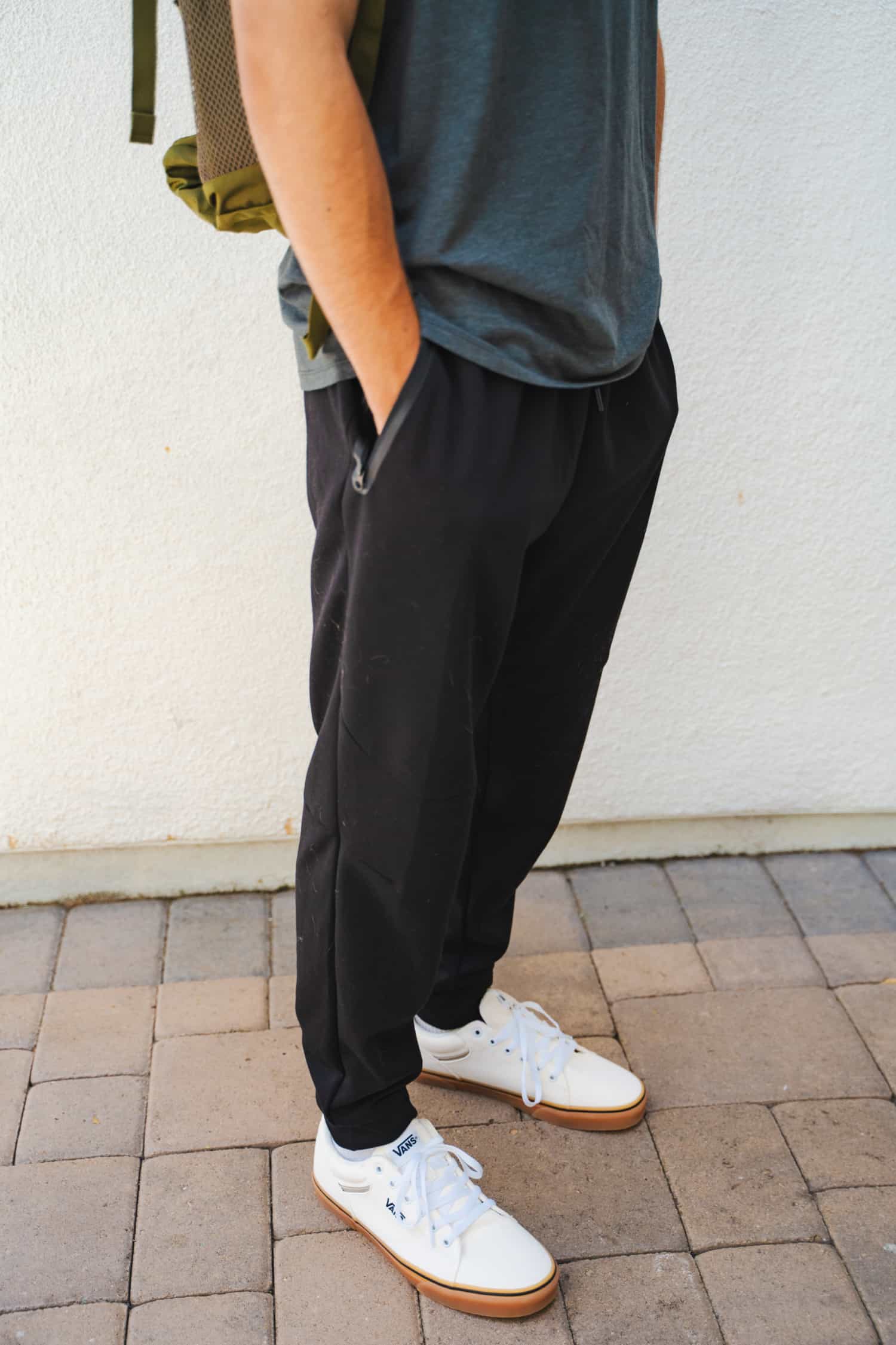 Side view of black jogger pants on a young male.
