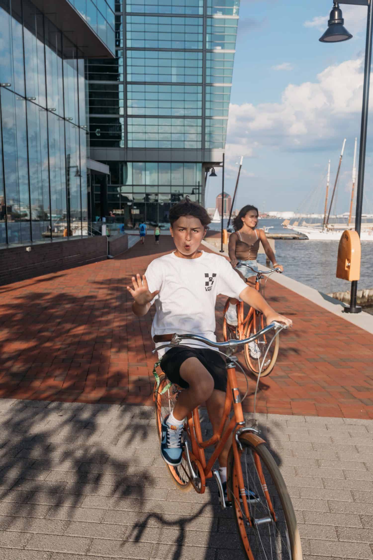 boy riding on a bike with a girl in the background